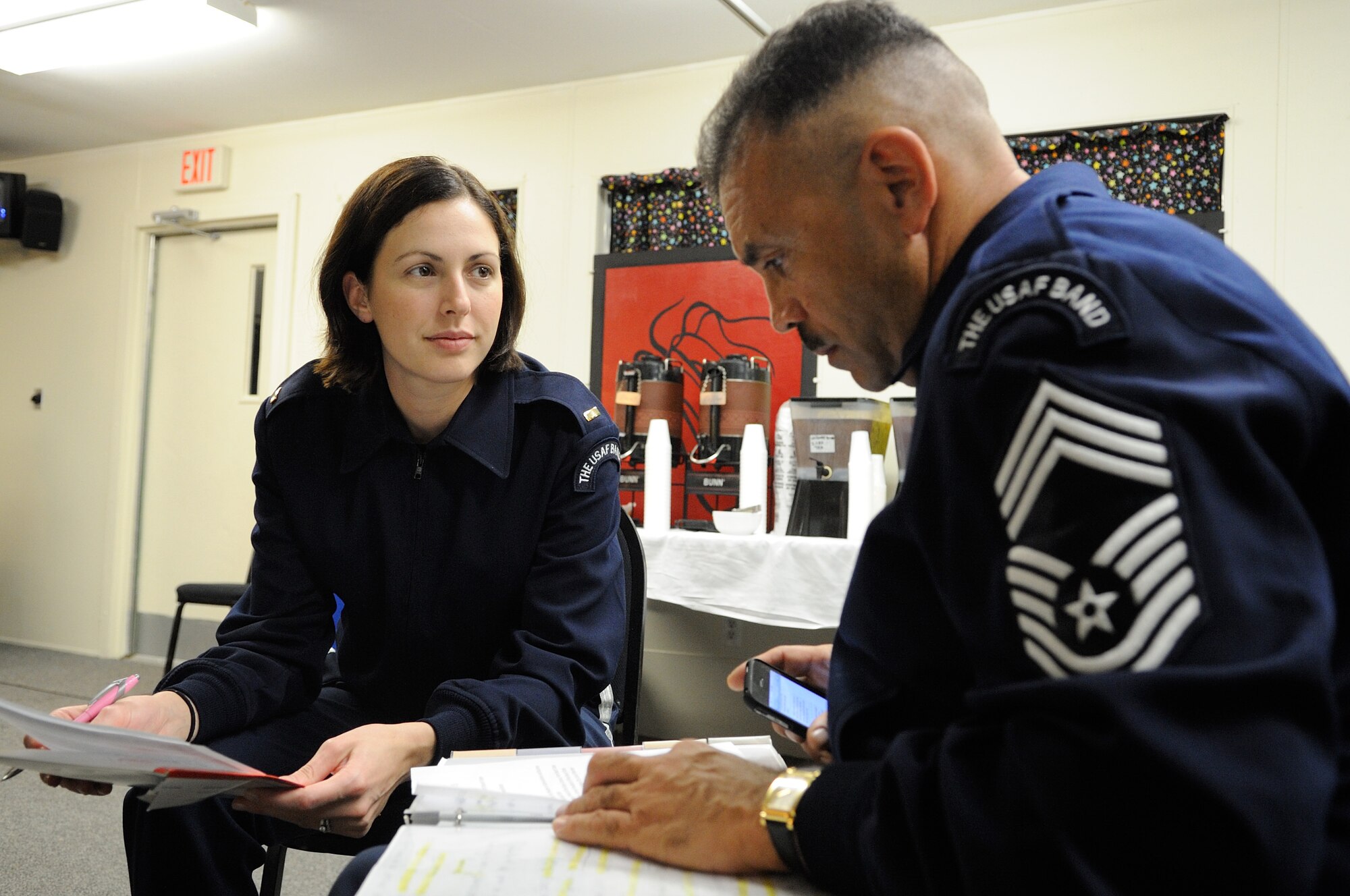 U.S. Air Force 2nd Lt. Shanti Nolan, a conductor with the U.S. Air Force Band Ceremonial Brass and a native of Vero Beach, Fla., talks about the tour script with U.S. Air Force Chief Master Sgt. Edward Teleky, the drum major of the U.S. Air Force Band and noncommissioned officer in charge of the Ceremonial Brass, before a concert Jan. 20, 2012, in Palm Beach Gardens, Fla.  Nolan, the newest member of the U.S. Air Force Band, is leading the Ceremonial Brass is on their first American concert tour, playing at a dozen venues throughout Florida.  U.S. Air Force photo by Master Sgt. Adam M. Stump/Released.