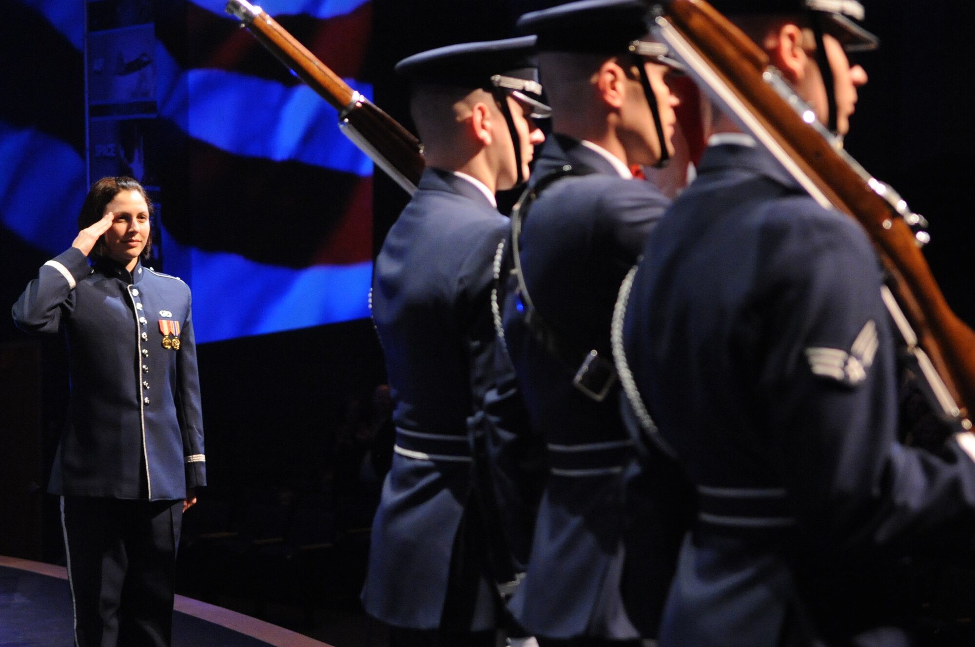 U.S. Air Force 2nd Lt. Shanti Nolan, a conductor with the U.S. Air Force Band Ceremonial Brass and a native of Vero Beach, Fla., salutes the U.S. flag carried by members of the U.S. Air Force Honor Guard during a concert Jan. 12, 2012, in Wesley Chapel, Fla.  Nolan, the newest member of the U.S. Air Force Band, is leading the Ceremonial Brass is on their first American concert tour, playing at a dozen venues throughout Florida.  U.S. Air Force photo by Master Sgt. Adam M. Stump/Released.