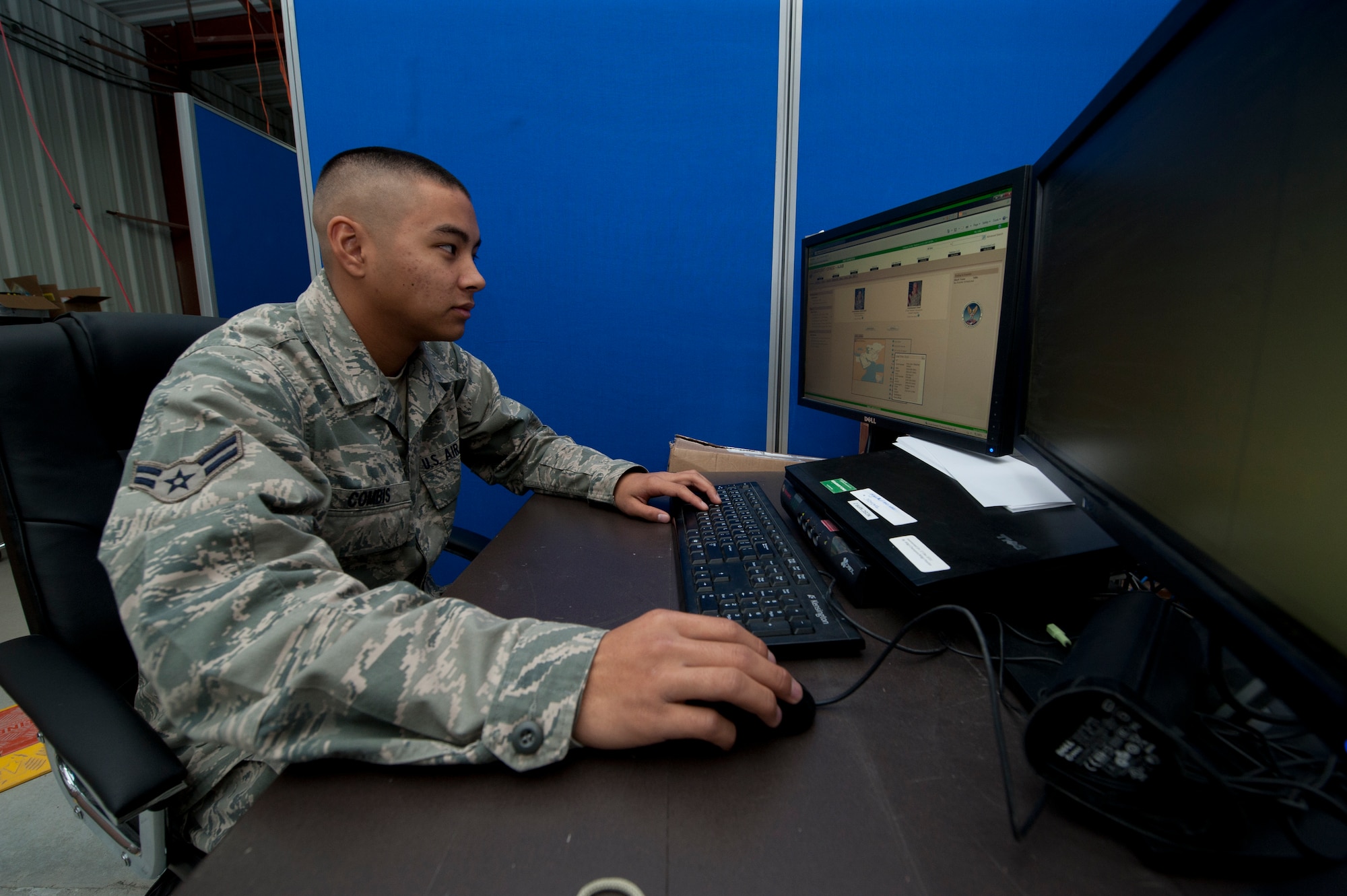 Airman 1st Class Kameron Combis, 332nd Expeditionary Communication Squadron Network Control Center operator, fixes a work ticket from his computer at an undisclosed location in Southwest Asia Jan. 20, 2012. Combis is able to troubleshoot certain computer network issues from his own workstation. Combis is one of two graduates from the Hawaii National Guard Youth Challenge Academy deployed to the 332nd Air Expeditionary Wing. Combis is deployed from the Hawaii Air National Guard. (U.S. Air Force photo by Staff Sgt. Joshua J. Garcia/Released)