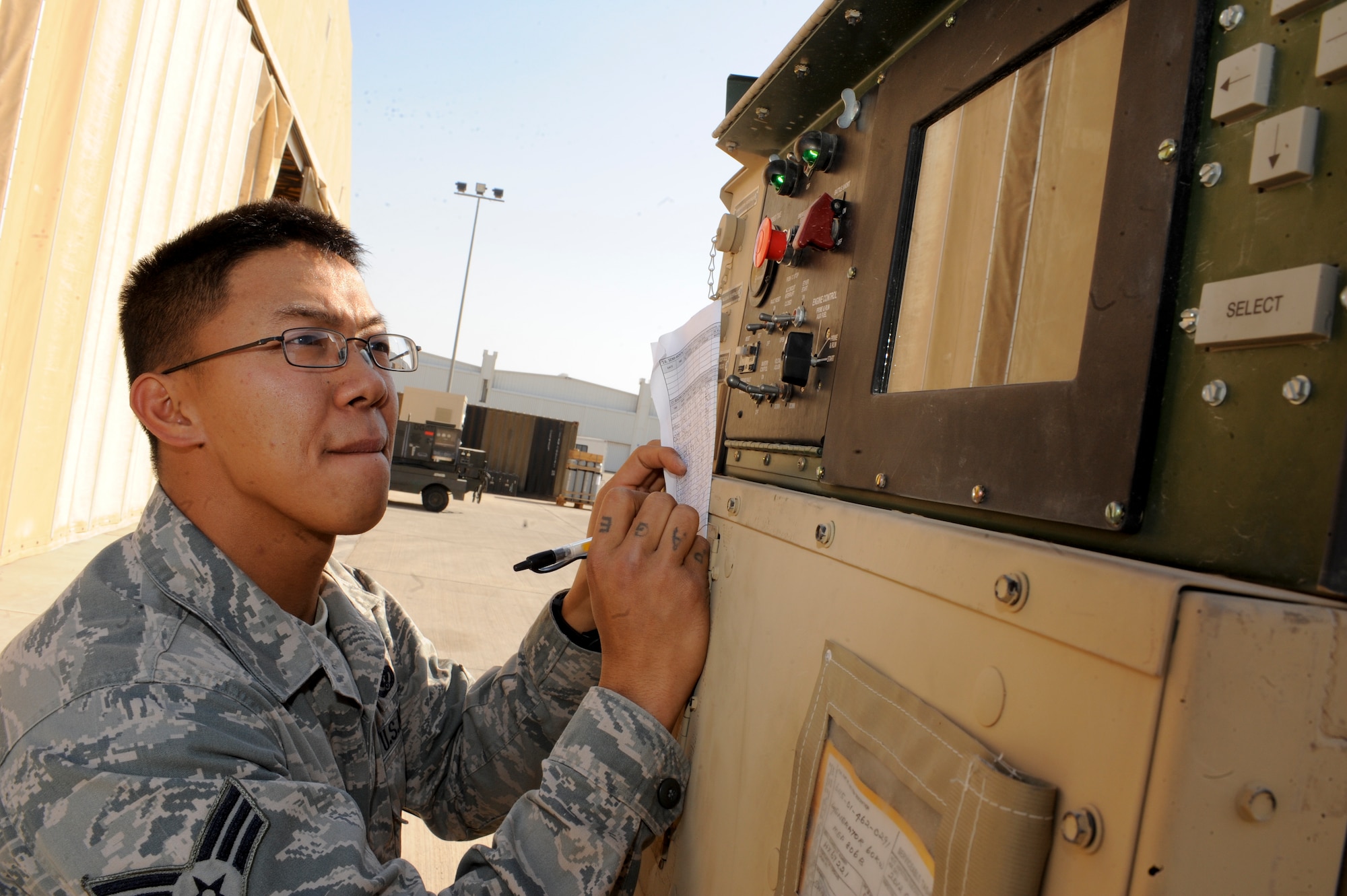 Senior Airman Ephesians Bagorio, 332nd Expeditionary Civil Engineer Squadron, checks a generator’s gas and oil pressure levels at an undisclosed location in Southwest Asia, Jan. 20, 2012. Bagorio has overcome many hardships in his past and has used lessons he learned at the Hawaii National Guard Youth Challenge Academy to thrive in his active-duty career. Bagorio is deployed from Davis-Monthan, Ariz., and is native to the state of Hawaii. (U.S. Air Force photo by Staff Sgt. Joshua J. Garcia/Released)