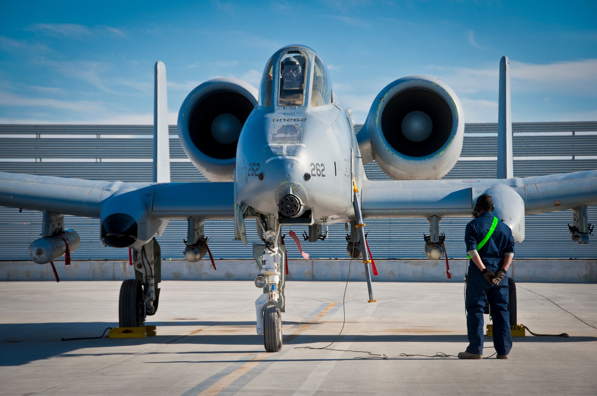 KANDAHAR AIRFIELD, Afghanistan -- A 451st Expeditionary Aircraft Maintenance Squadron crew chief waits for the pilot’s call to pull the chalks during an A-10 Thunderbolt II launch at Kandahar Airfield, Afghanistan Jan. 20, 2012. The A-10 can employ a wide variety of conventional munitions, including general purpose bombs, cluster bomb units and laser guided bombs. (U.S. Air Force photo by Staff Sgt. David Carbajal)