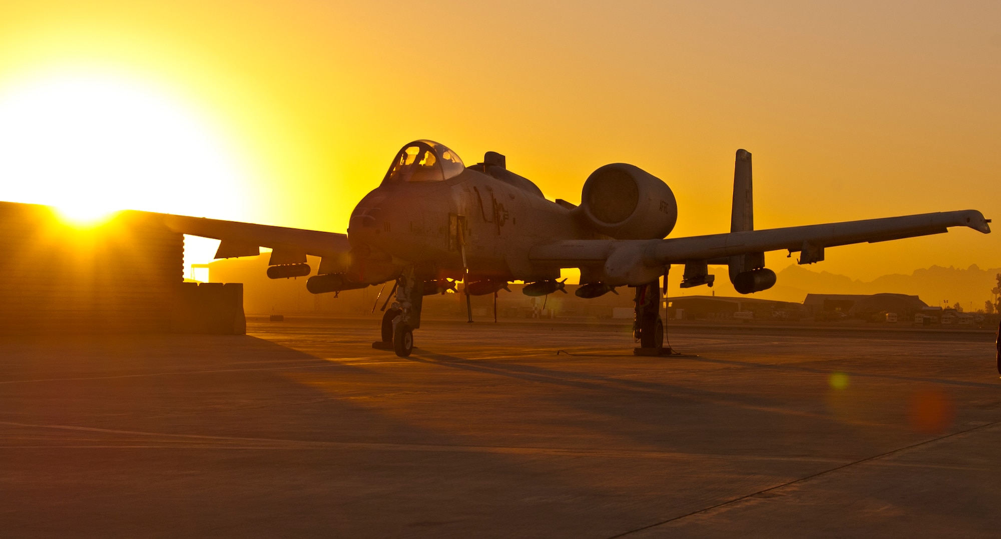 KANDAHAR AIRFIELD, Afghanistan -- A parked A-10 Thunderbolt II sits on the ramp in the early-morning hours at Kandahar Airfield, Afghanistan Jan. 20, 2012. Kandahar’s A-10s provide close-air support for U.S. and coalition ground troops throughout Afghanistan. (U.S. Air Force photo by Staff Sgt. David Carbajal)