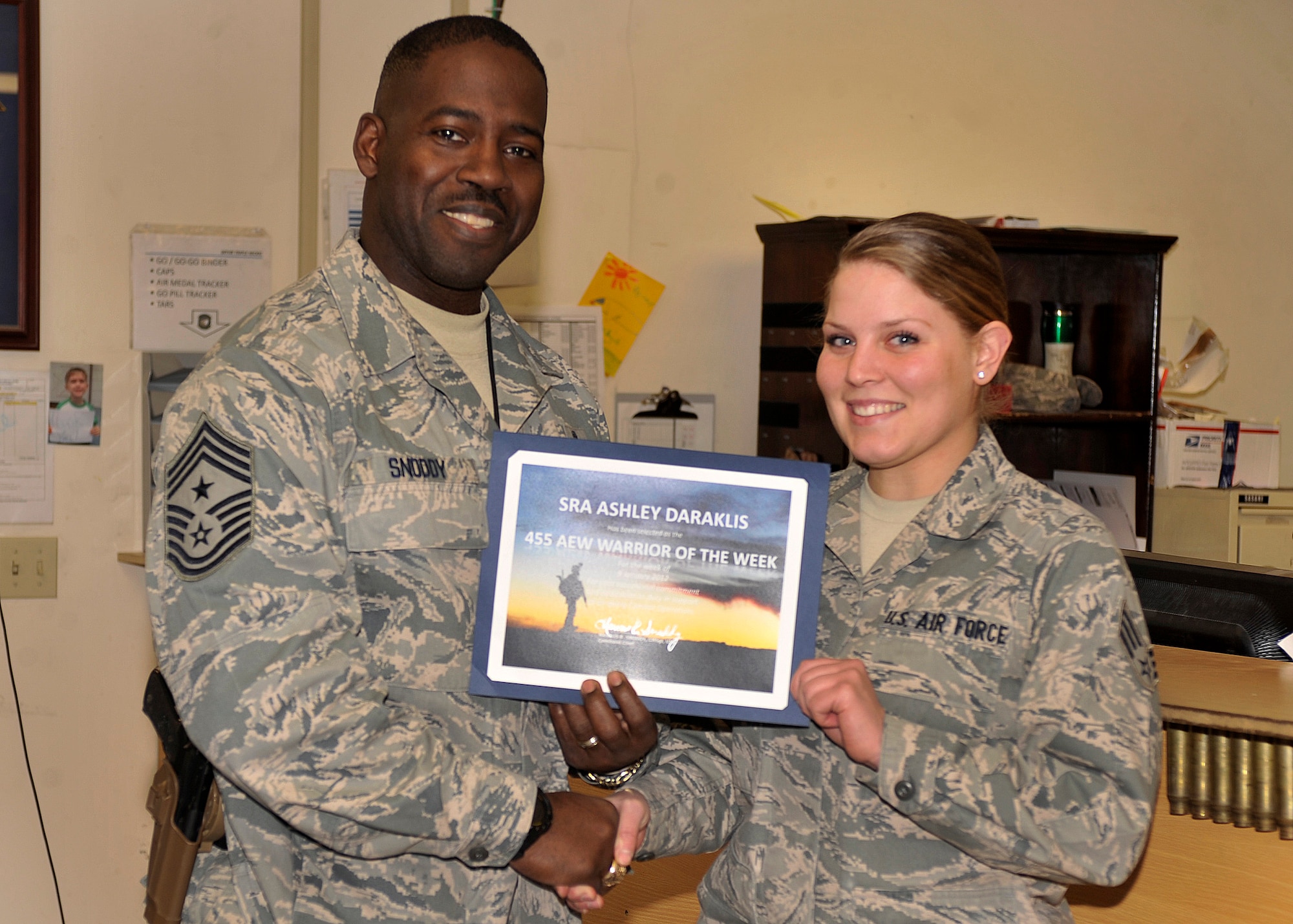 BAGRAM AIRFIELD, Afghanistan—Senior Airman Ashley receives the Warrior of the Week award from Chief Master Sgt. Marcus Snoddy at Bagram Airfield, Afghanistan, Jan. 20, 2012. Daraklis is an aviation resource manager with the 119th Expeditionary Force Squadron and received the Warrior of the Week award for her hard work and dedication to excellence.(U.S. Air Force photo/Airman 1st Class Ericka Engblom)