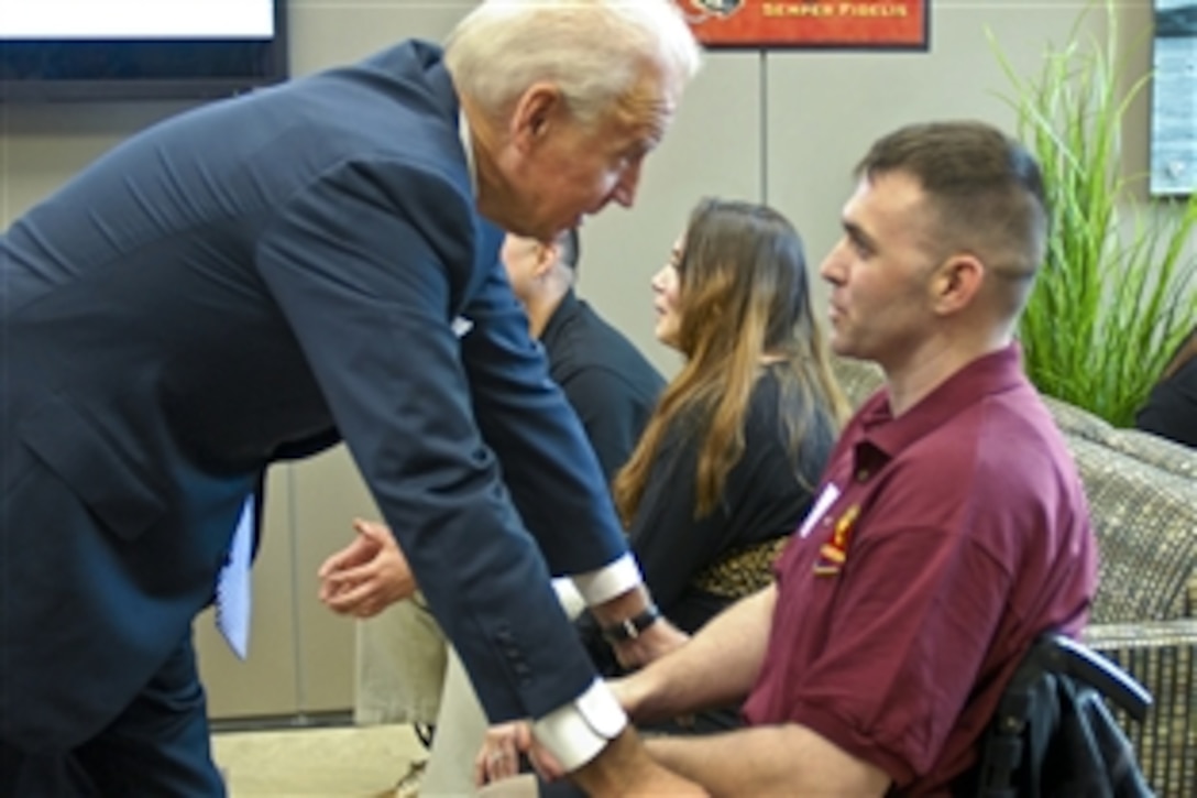 Vice President Joe Biden speaks with wounded warrior Marine Corps Sgt. James Amos during a visit to the Warrior Hope and Care Center on Marine Corps Base Camp Pendleton, Calif., Jan. 20, 2012.