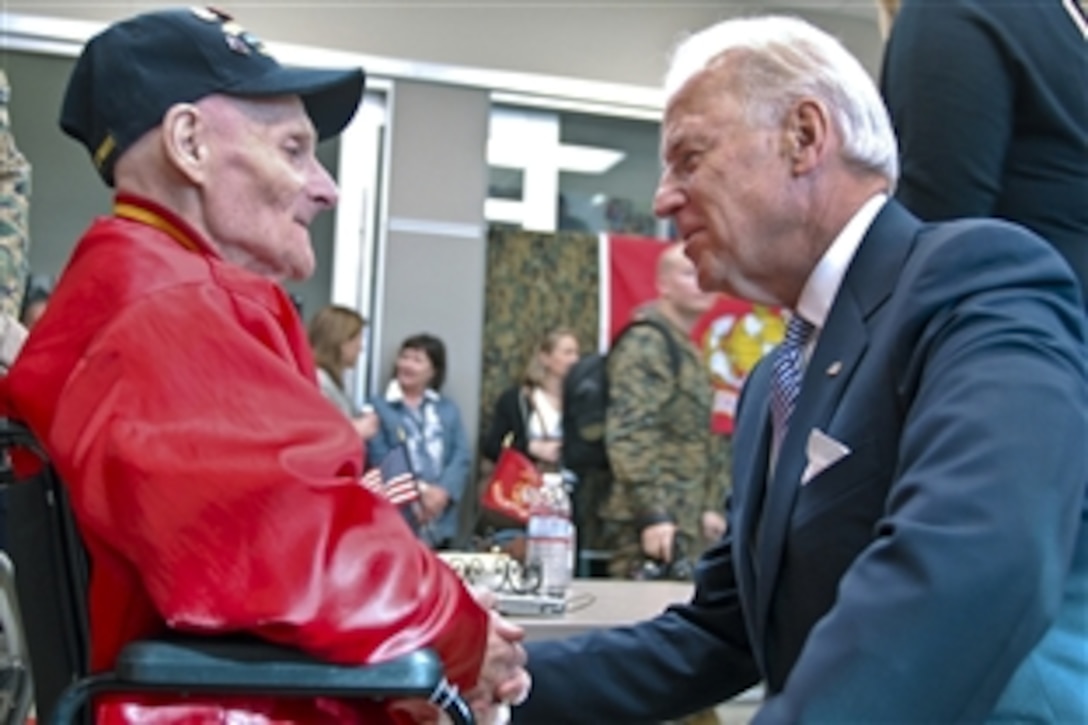 Vice President Joe Biden talks to World War II veteran Thomas Marino during a visit to the the Warrior Hope and Care Center on Marine Corps Base Camp Pendleton, Calif., Jan. 20, 2012. Marino was accompanied by his son, Marine Corps Gunnery Sgt. David Marino, and wife, Laura Marino.
