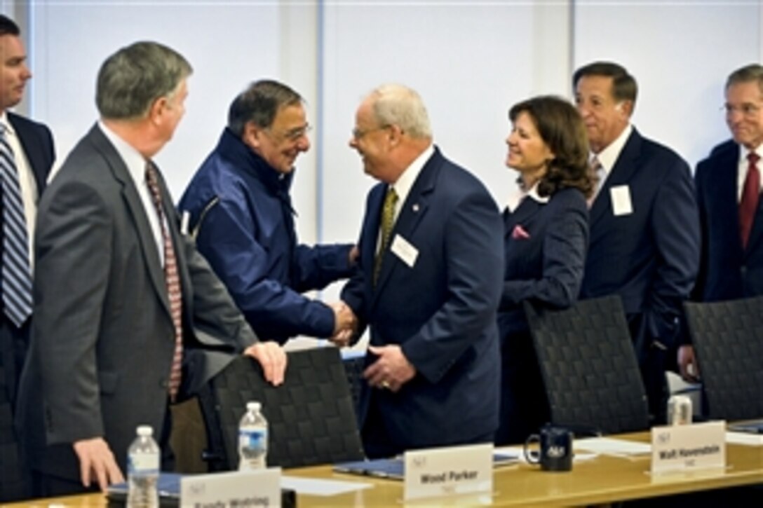 Defense Secretary Leon E. Panetta shakes hands with Walter P.Havenstein as he introduces himself during a meeting with representatives of the aerospace industry to discuss the impact of impending budget cuts on the department at the Aerospace Industries Association in Arlington, Va., Jan. 20, 2012. Havenstein is an association board member.