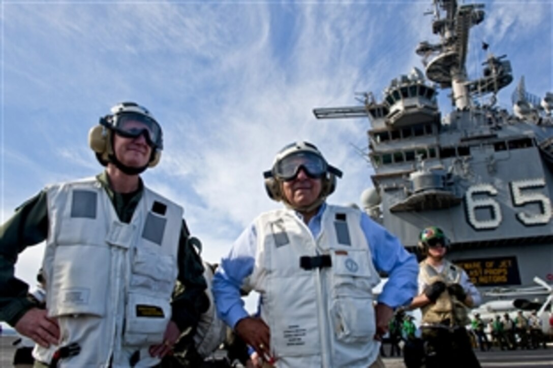 Defense Secretary Leon E. Panetta and Navy Rear Adm. Walter E. Carter Jr., commander of Carrier Strike Group 12, watch flight operations aboard the aircraft carrier USS Enterprise in the Atlantic Ocean, Jan. 21, 2012. The Enterprise Carrier Strike Group is conducting a composite training unit exercise.