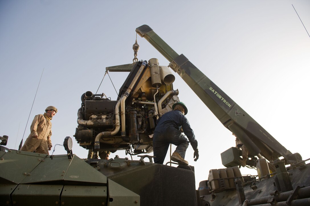 Marines serving with the 11th Marine Expeditionary Unit hoist an engine from an amphibious assault vehicle Jan. 21. The unit is currently deployed as part of the Makin Island Amphibious Ready Group, which is a U.S. Central Command theater reserve force providing support for maritime security operations and theater security cooperation efforts here.