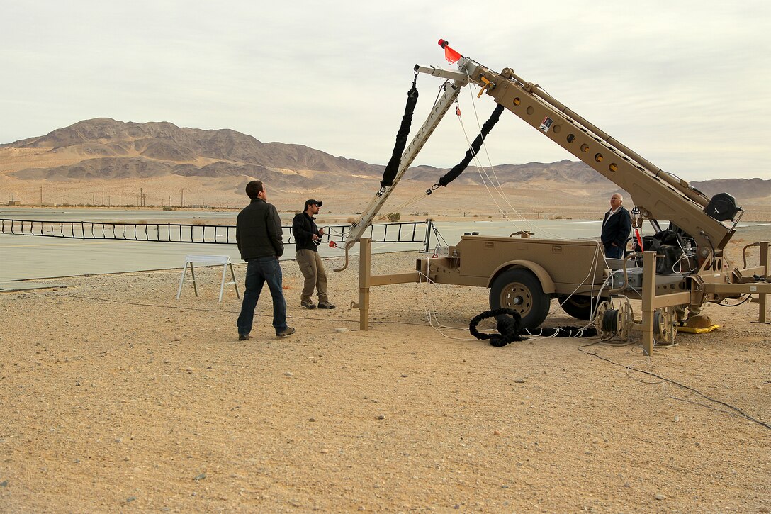 Field service representatives from Insitu and Boeing prepare the catcher for the military’s newest unmanned aerial vehicle, the Integrator, at VMU-3’s airfield Jan. 22, 2012.