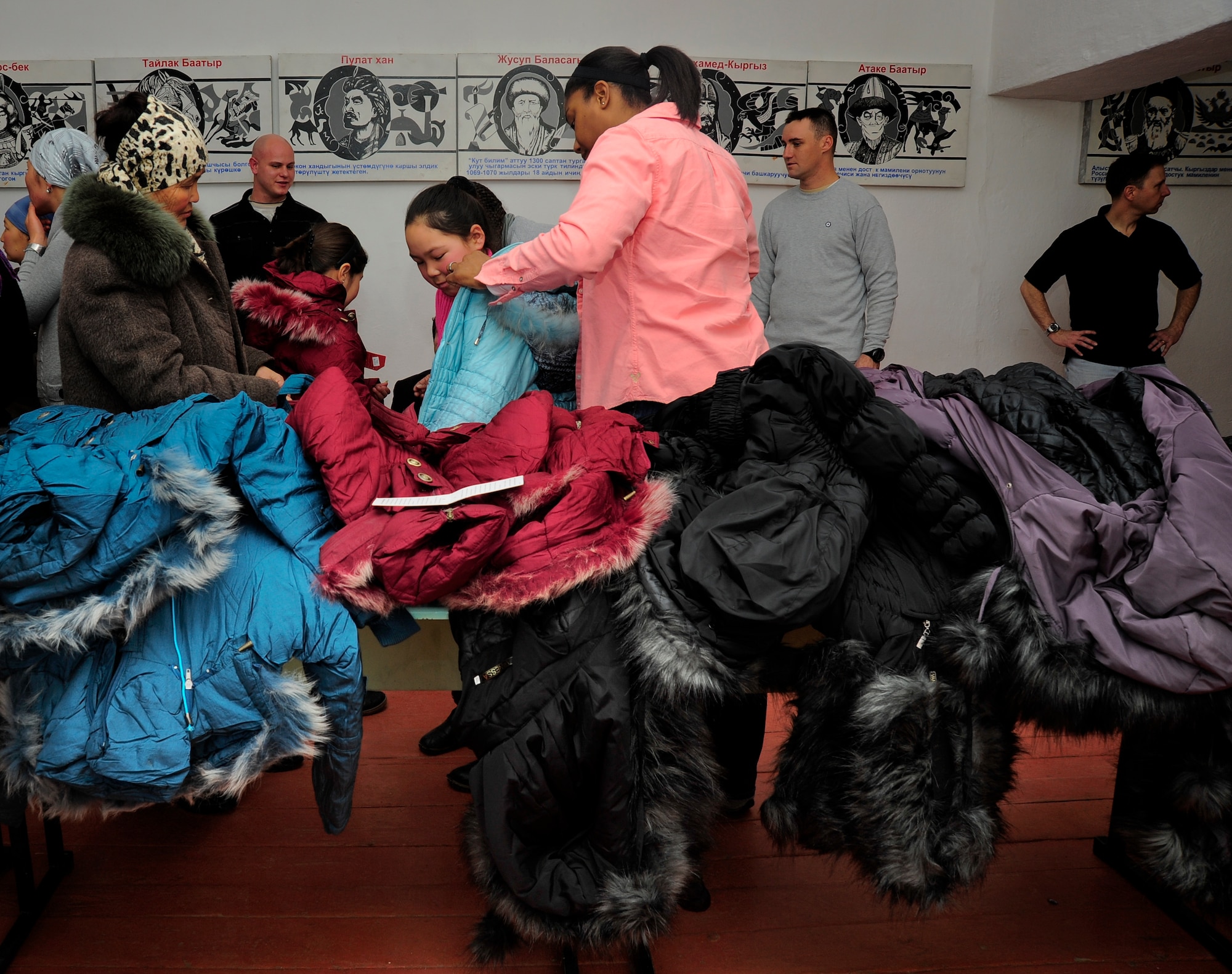 Coats cover a table at the Beat School Jan. 17, 2012, while Airmen with the 376th Air Expeditionary Wing distribute the coats to Kyrgyz citizens in Beat, Kyrgyzstan. The distribution was conducted during a five-day mission to the Issyk-Kul region. and more than 50 Airmen from the 376th AEW volunteered their time. (U.S. Air Force Photo/Staff Sgt. Angela Ruiz)