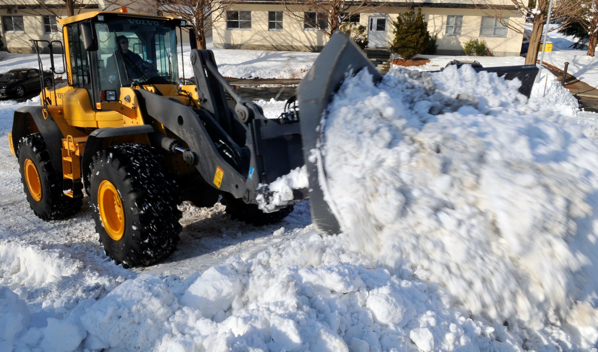 MISAWA AIR BASE, Japan – A frontend loader equipped with a plow pushes snow into a pile in base housing Jan. 19. The 35th Civil Engineer Squadron’s Snow Control Shop anticipates snowfall of approximately 125-200 inches this year. (U.S. Air Force photo by Tech. Sgt. Phillip Butterfield) 