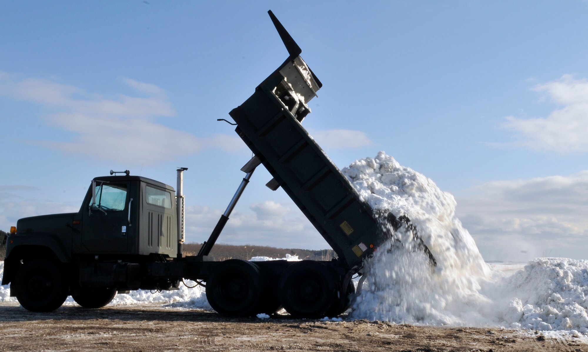 MISAWA AIR BASE, Japan – A 10-ton truck off-loads collected snow at the dump area Jan. 19. Each driver will make approximately 50 trips to the dump area each shift. (U.S. Air Force photo by Tech. Sgt. Phillip Butterfield) 