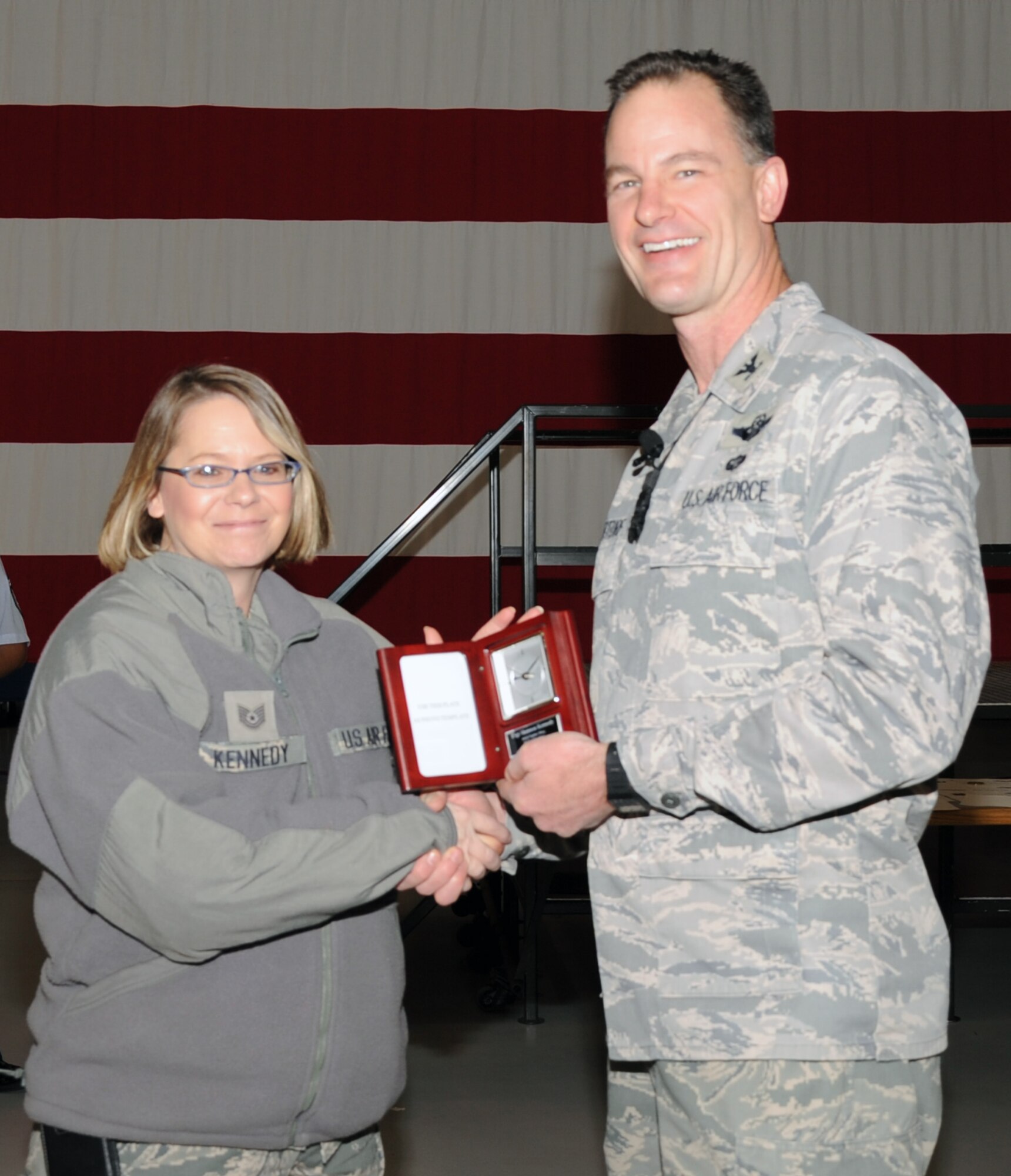 Col. Eric S. Overturf, 442nd Fighter Wing commander, presents Tech. Sgt. Shannon Kennedy, 442nd Force Support Squadron, with an award for Noncommissioned Officer of the Year 2011 at a ceremony, Jan. 22, 2012. During the presentation, Overturf announced all quarterly award winners for 2011 as well as the annual award winners. The 442nd FW is an A-10 Thunderbolt II Air Force Reserve unit at Whiteman Air Force Base, Mo. (U.S. Air Force photo/Senior Airman Wesley Wright)