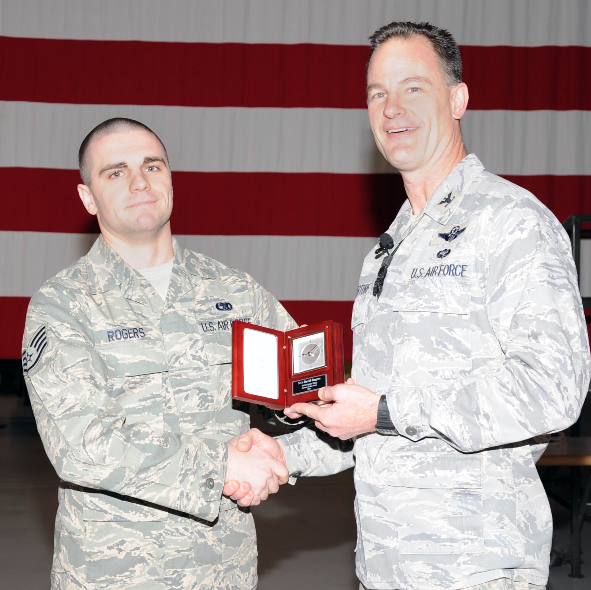 Col. Eric S. Overturf, 442nd Fighter Wing commander, presents Staff Sgt. David Rogers, 442nd Maintenance Squadron, with an award for Airman of the Year 2011 at a ceremony, Jan. 22, 2012. At the time Rogers was nominated for the award, he held the rank of senior airman. During the presentation, Overturf announced all quarterly award winners for 2011 as well as the annual award winners. The 442nd FW is an A-10 Thunderbolt II Air Force Reserve unit at Whiteman Air Force Base, Mo. (U.S. Air Force photo/Senior Airman Wesley Wright)