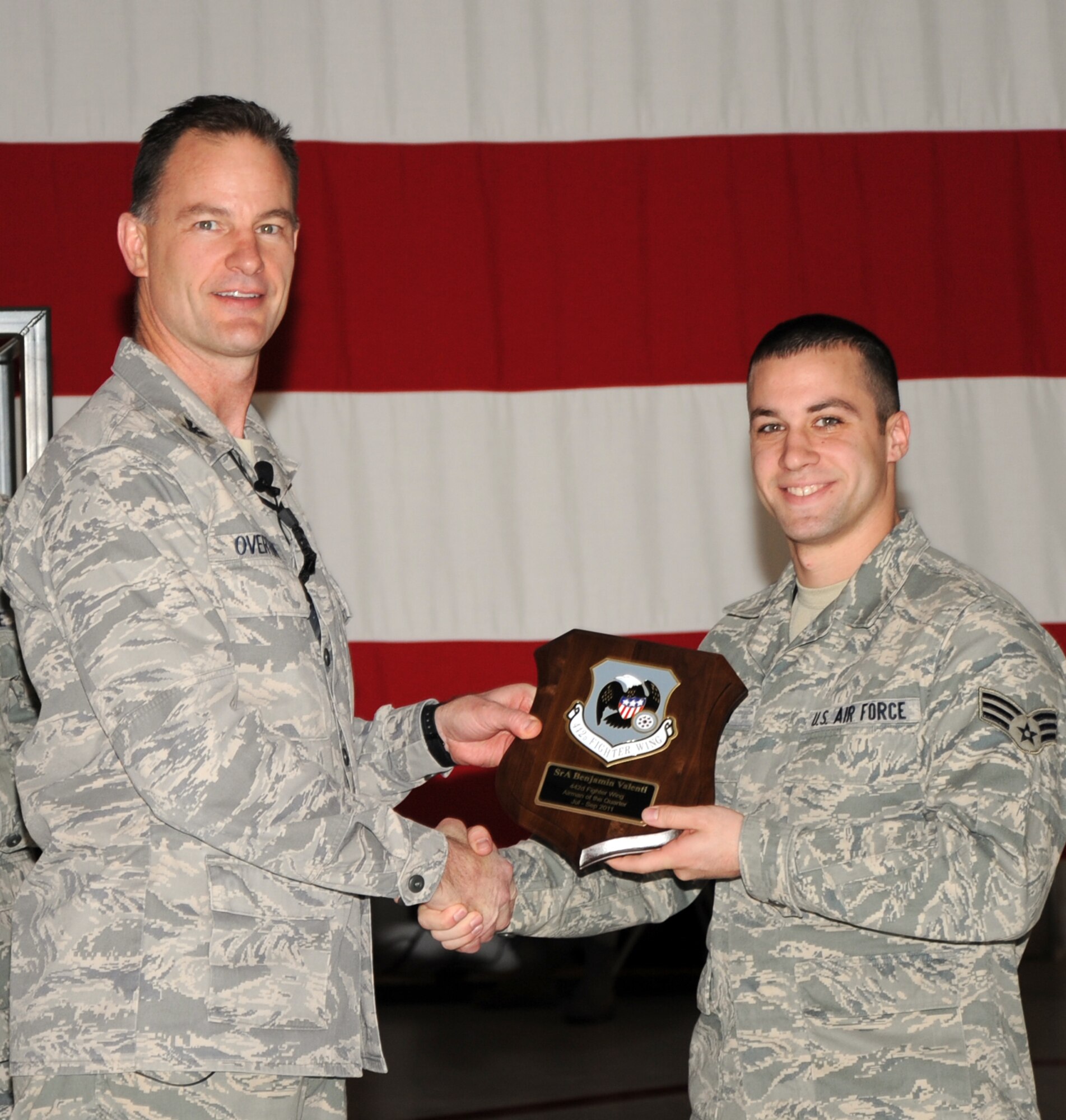 Col. Eric S. Overturf, 442nd Fighter Wing commander, presents Senior Airman Benjamin Valenti, 442nd Maintenance Squadron, with a quarterly award for Airman of the Quarter 2011 at a ceremony, Jan. 22, 2012. During the presentation, Overturf announced all quarterly award winners for 2011 as well as the annual award winners. The 442nd FW is an A-10 Thunderbolt II Air Force Reserve unit at Whiteman Air Force Base, Mo. (U.S. Air Force photo/Senior Airman Wesley Wright)