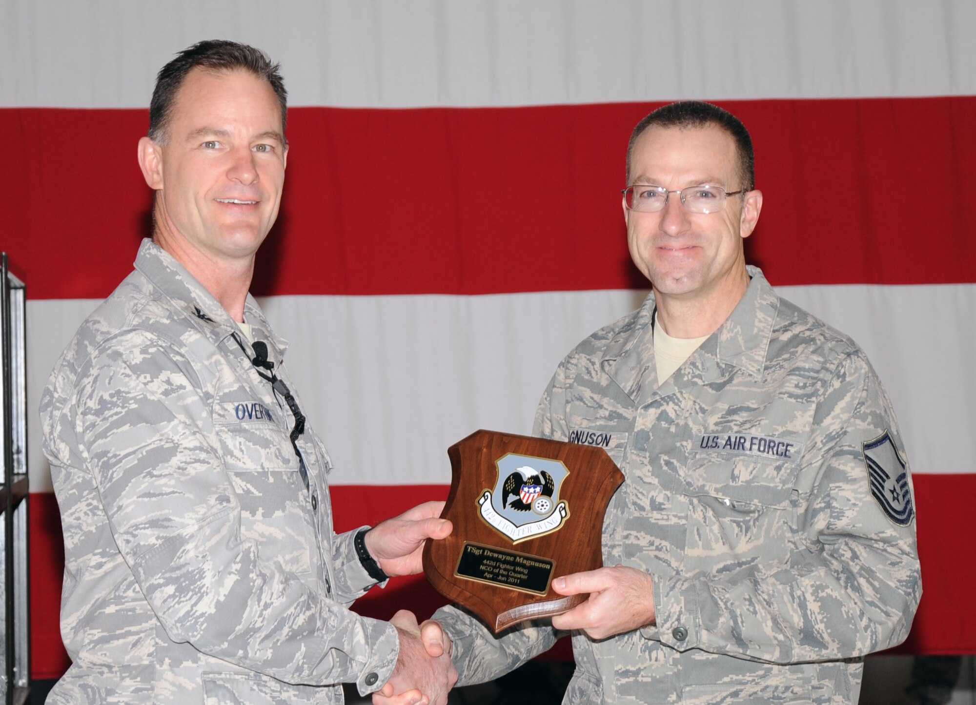 Col. Eric S. Overturf, 442nd Fighter Wing commander, presents Master Sgt. DeWayne Magnuson, 442nd Maintenance Group, with the award for Noncommissioned Officer of the First Quarter 2011 at a ceremony, Jan. 22, 2012. When Magnuson was nominated for the award, he held the rank of technical sergeant. During the presentation, Overturf announced all quarterly award winners for 2011 as well as the annual award winners. The 442nd FW is an A-10 Thunderbolt II Air Force Reserve unit at Whiteman Air Force Base, Mo. (U.S. Air Force photo/Senior Airman Wesley Wright)