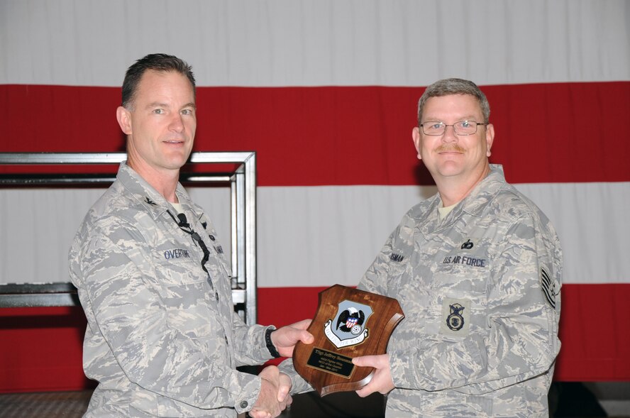 Col. Eric S. Overturf, 442nd Fighter Wing commander, presents Tech. Sgt. Jeffrey Bousman, 442nd Security Forces Squadron, with the award for Noncommissioned Officer of the First Quarter 2011 at a ceremony, Jan. 22, 2012. During the presentation, Overturf announced all quarterly award winners for 2011 as well as the annual award winners. The 442nd FW is an A-10 Thunderbolt II Air Force Reserve unit at Whiteman Air Force Base, Mo. (U.S. Air Force photo/Senior Airman Wesley Wright)