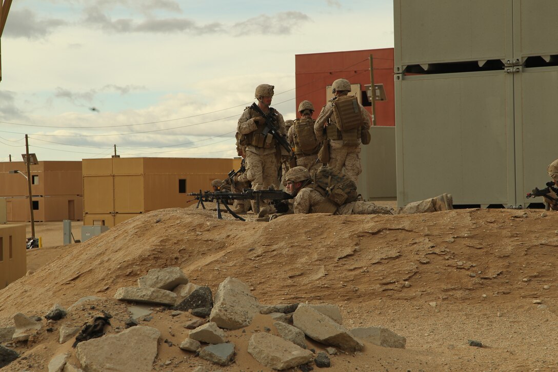 Marines with Company C, 1st Battalion, 7th Marine Regiment, provide cover after they clear a lane during the Clear, Hold, Build 1 stage of their Enhanced Mojave Viper cycle Jan. 23, 2012.::r::::n::