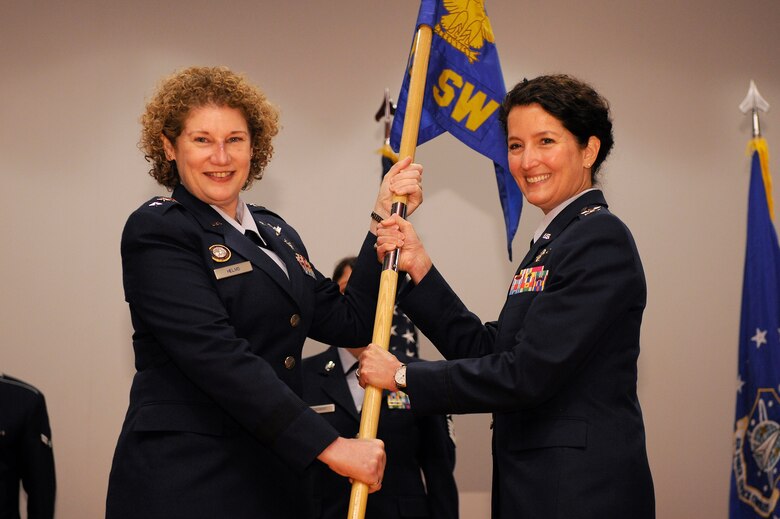VANDENBERG AIR FORCE BASE, Calif. -- Lt. Gen. Susan Helms, the Joint Functional Component Command for Space and 14th Air Force commander, hands off the 30th Space Wing guidon to Col. Nina Armagno, 30th SW commander, during the change of command ceremony at the base theater Monday, Jan. 23, 2012. Armagno assumed command from Col. Richard Boltz upon his selection for reassignment to U.S. Strategic Command where he will serve as the battle watch commander in the Global Operations Center at Offutt Air Force Base, Neb. (U.S. Air Force photo/Staff Sgt. Levi Riendeau)