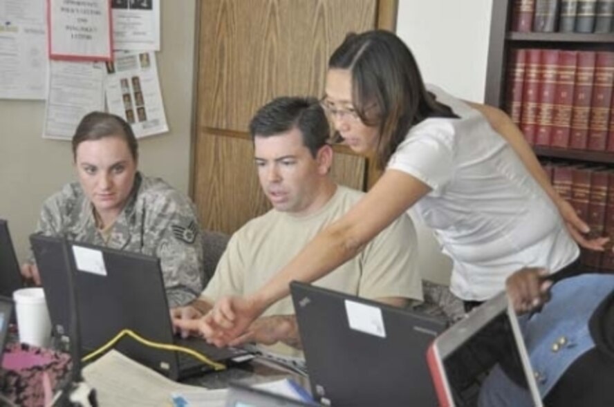 Staff Sgt. Sara Luna and Master Sgt. David Haug, 912th Air Refueling Squadron, receive guidance from Ali Frank, Internal Revenue Service senior tax consultant, during a six-hour training session held in the legal office, Jan. 18. The airmen are part of a group of volunteers who received tax law training last week and will spend this week learning TaxWise, the online computer software they’ll be using to process tax returns at the March VITA Center. (U.S. Air Force photo by Megan Crusher) 