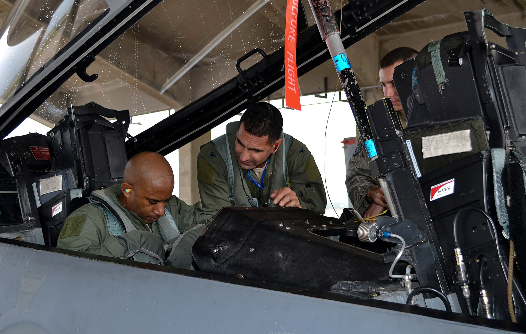 U.S. Air Force Col. David Nahom, 18th Operations Group commander, helps Chief Master Sgt. Mychael Bland, 18th OG superintendent, unlatch his safety harness inside a U.S. Air Force F-15 Eagle following Bland's incentive flight on Kadena Air Base, Japan, Jan. 13, 2012. Bland, who has served the U.S. Air Force longer than the average age of all enlisted Airmen, plans to draw the final curtain on his Air Force career following his retirement Jan. 27. (U.S. Air Force photo by Maj. Christopher Anderson/Released)