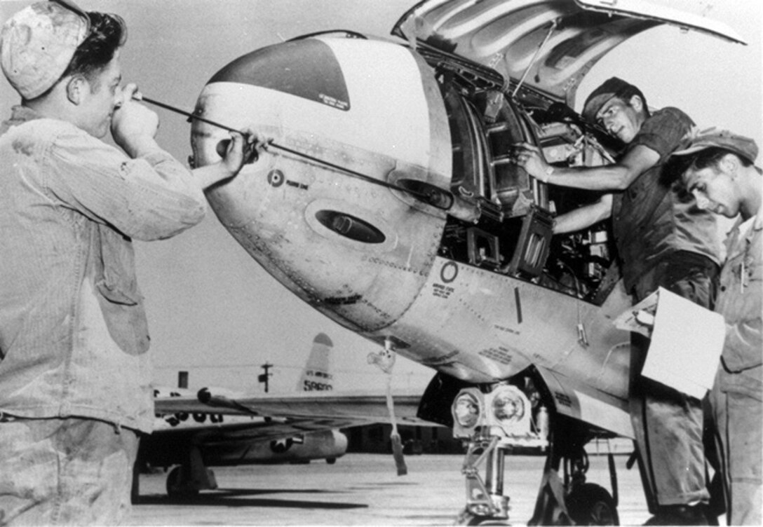 1952 -- Mechanics clean the guns on an F-80 in preparation for another gunnery training mission mission at Luke Air Force Base, Ariz. (Courtesy photo)