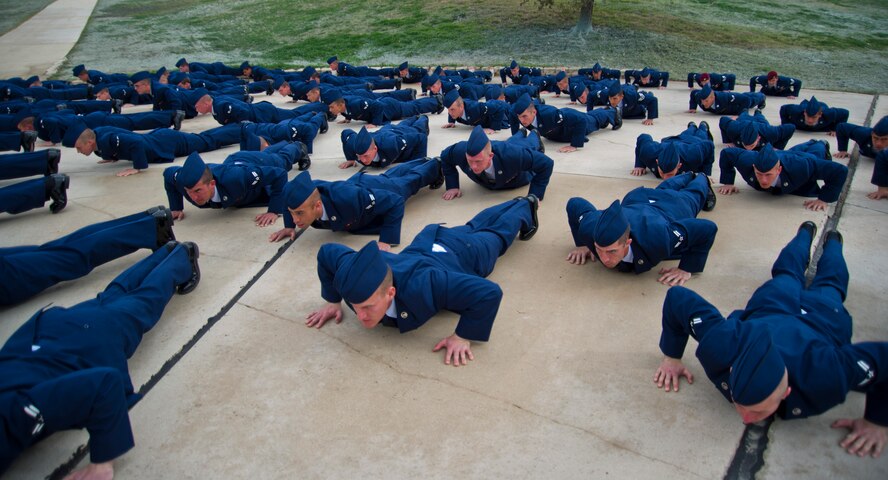 Pararescuemen, combat controllers and Pararescue Indoctrination Course trainees perform ???memorial push-ups??? during the memorial unveiling ceremony honoring Staff Sgt. Scott D. Sather, Jan. 20, 2012, Medina Annex, Lackland Air Force Base, San Antonio, Texas. Sather was the United States Air Force???s first combat casualty during Operation Iraqi Freedom. Sather???s memorial was created and displayed by Civil Engineers in Iraq to honor his leadership and bravery. His memorial was then transported to Lackland AFB, Texas in March 2011.  (U.S. Air Force photo by Senior Airman Marleah Miller)