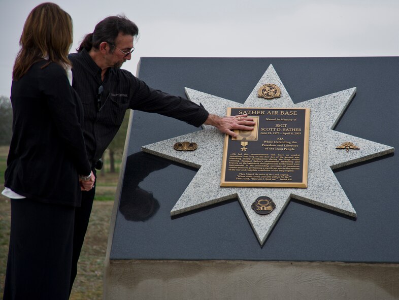 Melanie Sather, spouse of Staff Sgt. Scott D. Sather, and a family member pay their respect at the unveiling of Sgt. Sather???s memorial, Jan. 20, 2012, Medina Annex, Lackland Air Force Base, San Antonio, Texas. The 12,000 pound memorial was sea-lifted from Iraq to Lackland, AFB, Texas. (U.S. Air Force photo by Senior Airman Marleah Miller)