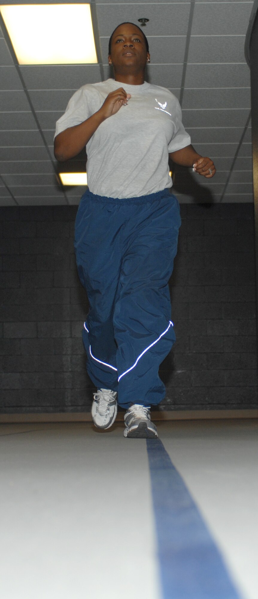 U.S. Air Force Senior Airman Kellie Jones, 355th Force Support Squadron fitness specialist, runs laps on the indoor track at the Benko Fitness Center on Davis-Monthan Air Force Base, Ariz. Jan. 19. The Benko Fitness Center keeps Airmen fit to fight. (U.S. Air Force photo by Airman 1st Class Michael Washburn/Released)
