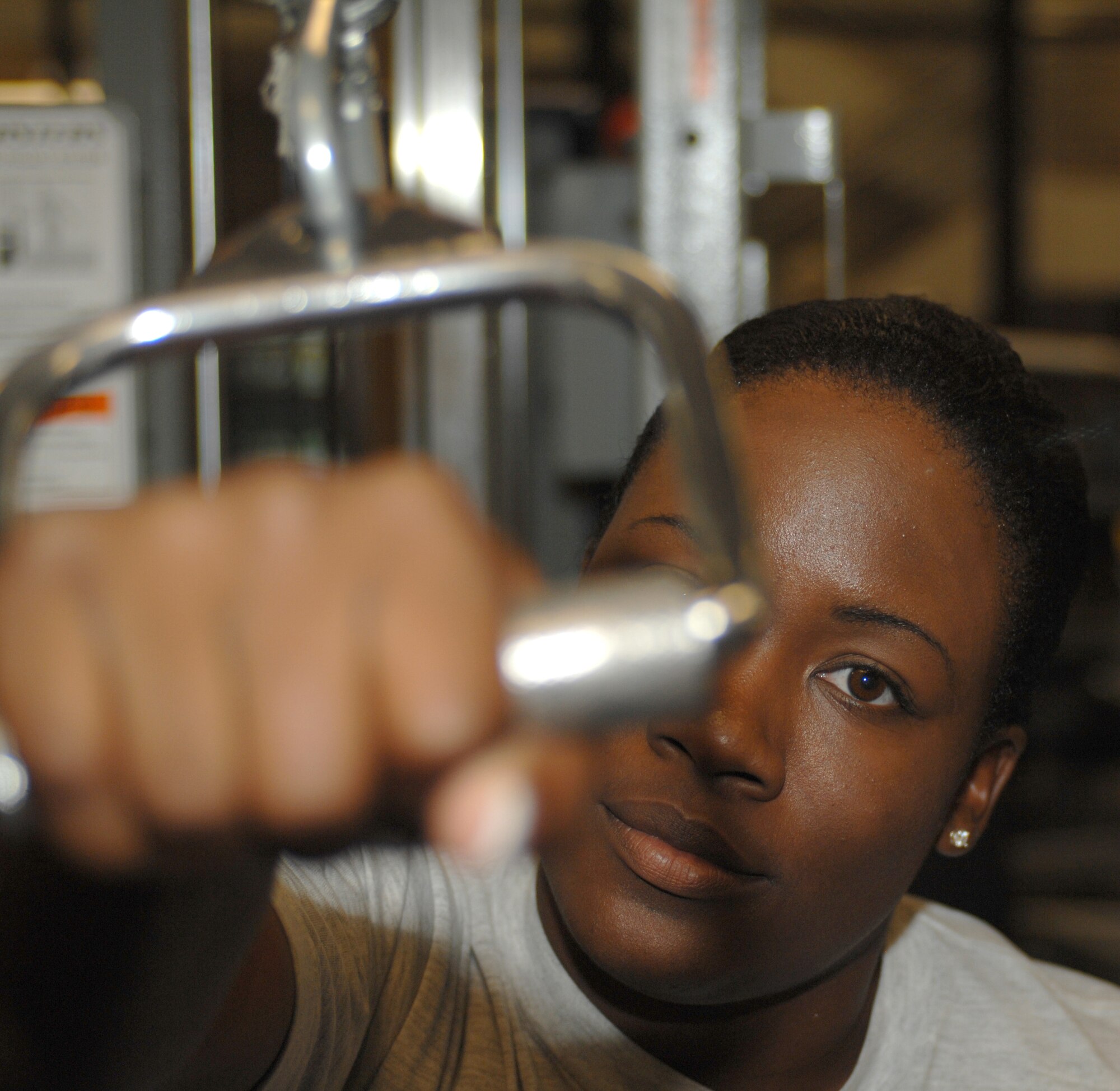 U.S. Air Force Senior Airman Kellie Jones, 355th Force Support Squadron fitness specialist, works out her arms at the Benko Fitness Center on Davis-Monthan Air Force Base, Ariz. Jan. 19. The Benko Fitness Center keeps Airmen fit to fight. (U.S. Air Force photo by Airman 1st Class Michael Washburn/Released)