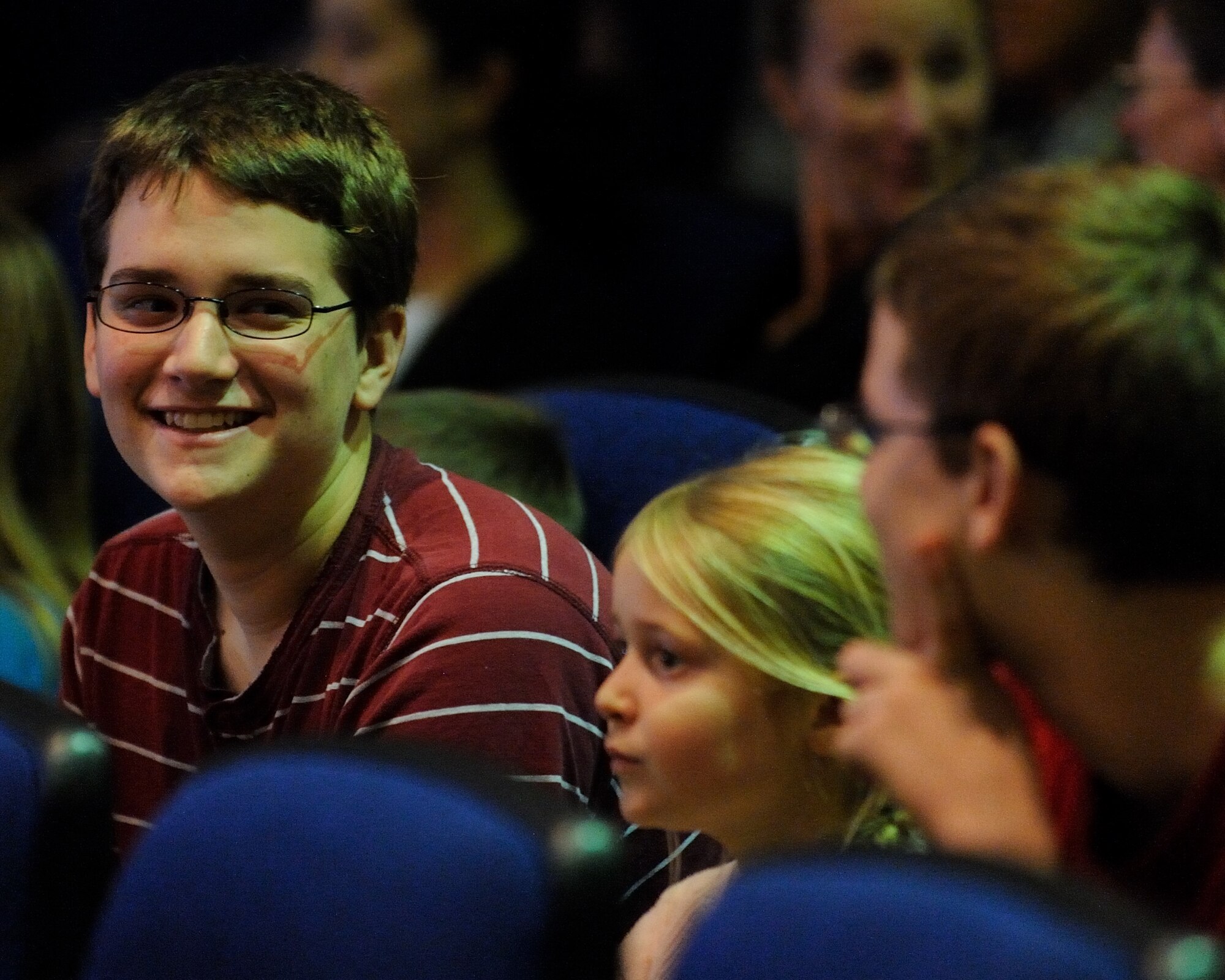 A young fan talks to a friend after hearing the "Star Wars" theme during a concert by the U.S. Air Force Band Ceremonial Brass at MacDill Air Force Base, Fla., Jan. 23, 2012.  The Ceremonial Brass toured Florida Jan. 11-23 playing their first ever American concert tour.  U.S. Air Force photo by Master Sgt. Adam M. Stump/RELEASED.