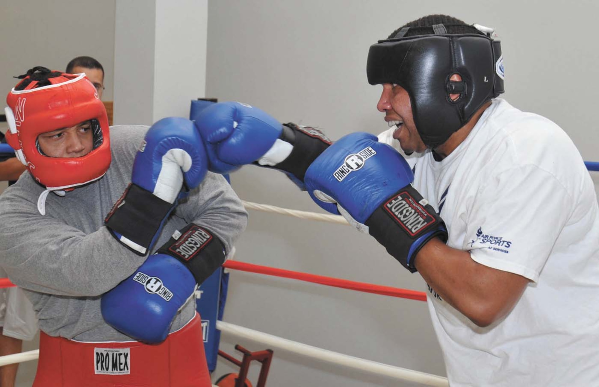 Air Force boxer Kent Brinson fends off a right jab from opponent Forrest Booker during a sparring session at the Chaparral Fitness Center. (U.S. Air Force photo/Alan Boedeker)