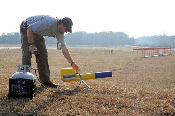 Dennis Lewis turns on a cannon during a wildlife patrol on Seymour Johnson Air Force Base, N.C., Jan. 20, 2012. The cannon shoots three to four bangers every minute to harass wildlife. A banger is an explosive cartridge that makes a loud bang to repel birds. Lewis is a U.S. Department of Agriculture specialist from Milan, Tenn. (U.S. Air Force photo/Senior Airman Whitney Stanfield)