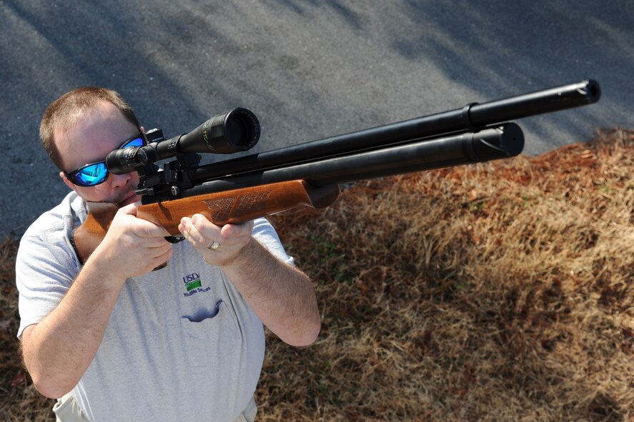 Chris Willis aims a pellet gun at a pigeon during a wildlife patrol on Seymour Johnson Air Force Base, N.C., Jan. 20, 2012. There is zero tolerance for pigeons on base because they post an aircraft bird strike risk. Willis is a U.S. Department of Agriculture wildlife biologist from Hickory, N.C. (U.S. Air Force photo/Senior Airman Whitney Stanfield)