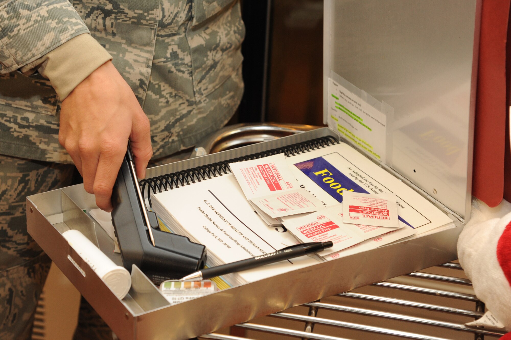 Senior Airman Sara Moreno places a thermometer back inside an inspection kit at the base commissary on Seymour Johnson Air Force Base, N.C., Jan. 18, 2012. An inspection kit includes a 2005 FDA Food Code book, alcohol wipes, sanitizer strips, thermometers, writing utensils and a note pad to document the inspector’s finding. Moreno is a 4th MDG public health technician from Mountain Home, Idaho. (U.S. Air Force photo/Senior Airman Whitney Stanfield)