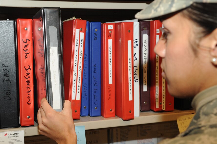 Senior Airman Sara Moreno grabs an evaluation binder for an inspection at the base commissary on Seymour Johnson Air Force Base, N.C., Jan. 18, 2012. The 4th Medical Group public health flight ensures each facility documents sanitation practices daily. Moreno is a 4th MDG public health technician from Mountain Home, Idaho. (U.S. Air Force photo/Senior Airman Whitney Stanfield) 