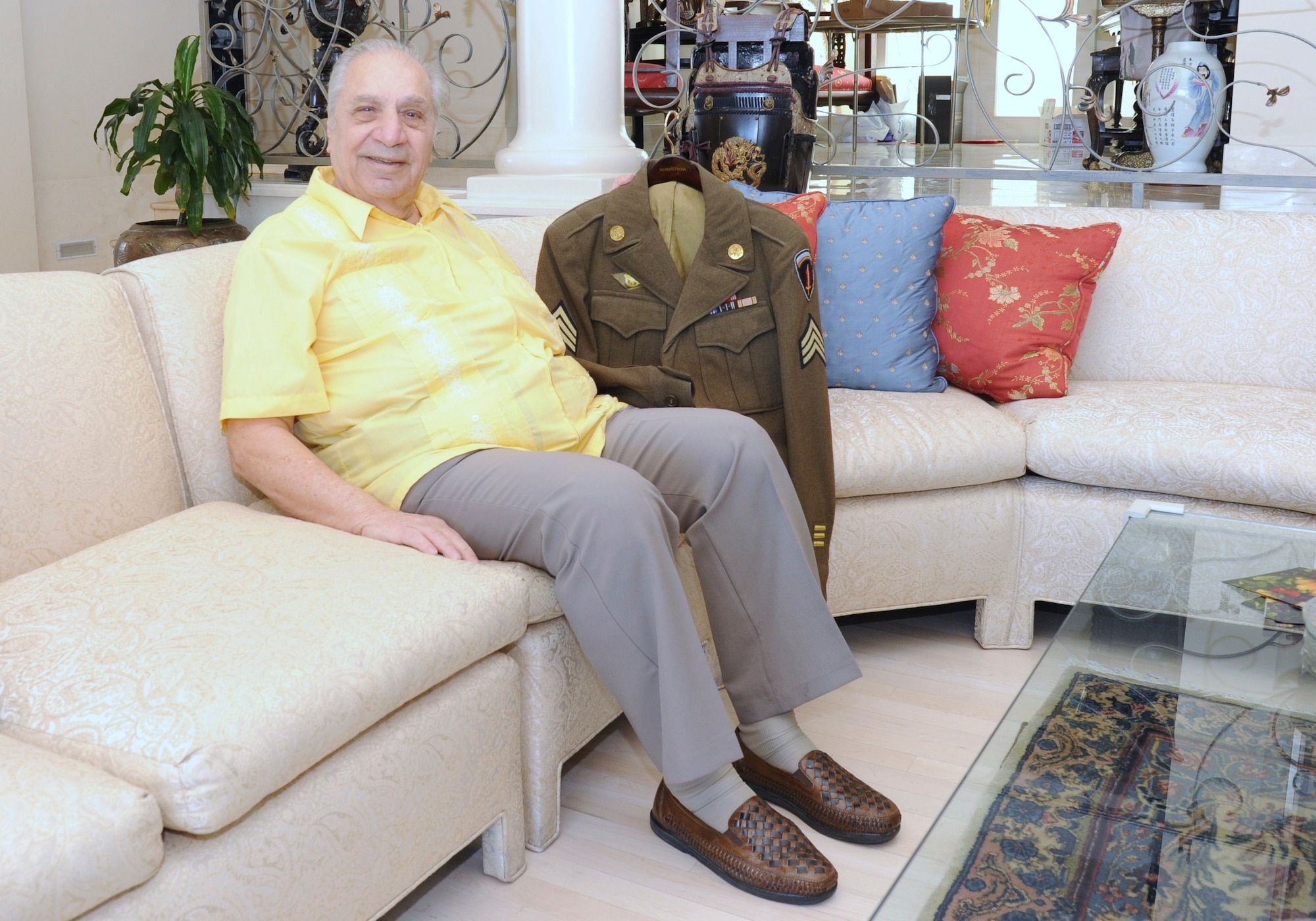 Gregory Melikian, a World War II veteran and Luke Air Force Base honorary commander, displays his Army service jacket from that period at his house in Phoenix Jan. 6. The patch on the right sleeve indicates the Meritorius Unit Award, which was among the first of this award ever given.