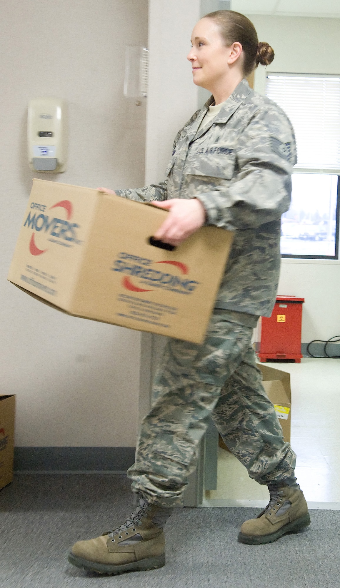 Tech. Sgt. Breah Misho, NCO in charge of public health with the 436th Aerospace Medicine Squadron, carries a box at the 436th Medical Group temporary facilities Jan. 23, 2012, at Dover Air Force Base, Del. The mental health, public health and flight medicine flights relocated from temporary facilities to the medical clinic, which had renovated 55,000 square feet at a cost of $17.1 million. (U.S. Air Force photo by Adrian R. Rowan)