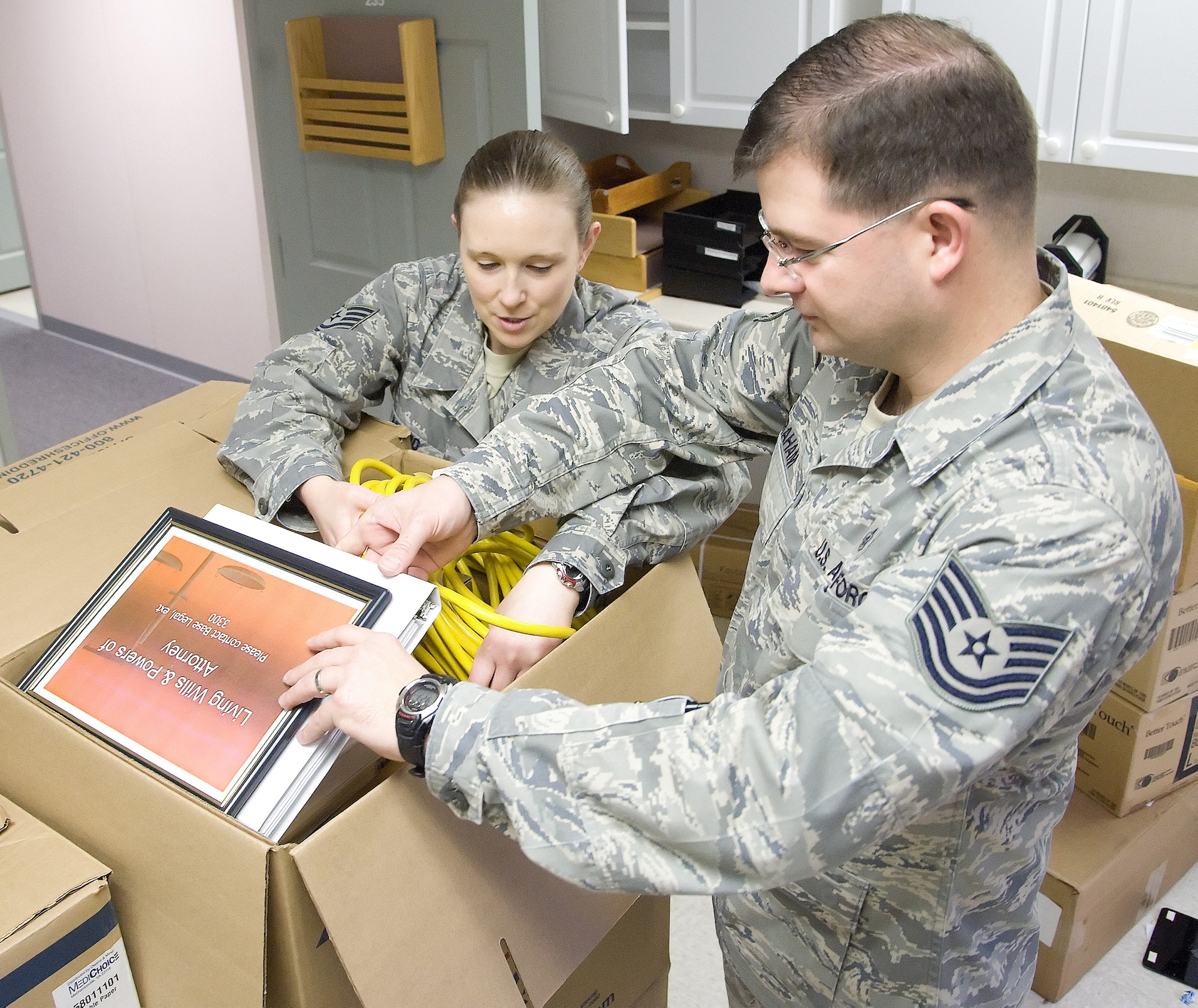 Tech. Sgts. Breah Misho, left, NCO in charge of public health with the 436th Aerospace Medicine Squadron, and John Graham, NCOIC of flight medicine with the 436th Medical Operations Squadron, pack a box at the 436th Medical Group temporary facilities Jan. 23, 2012, at Dover Air Force Base, Del. The mental health, public health and flight medicine flights relocated from temporary facilities to the medical clinic, which had renovated 55,000 square feet at a cost of $17.1 million. (U.S. Air Force photo by Adrian R. Rowan)