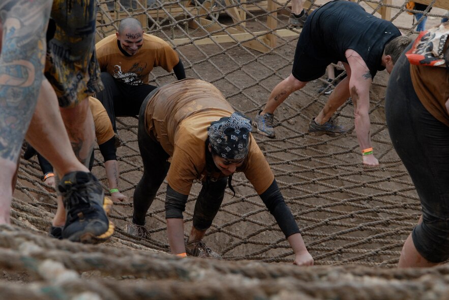 Jessica Saldana, Luke Air Force Base, Ariz., bear crawls through the rope ladder in the Tough Mudder Jan. 14 at the Mesa Proving Grounds in Mesa, Ariz. (U.S. Air Force photo by Airman 1st Class David Owsianka)