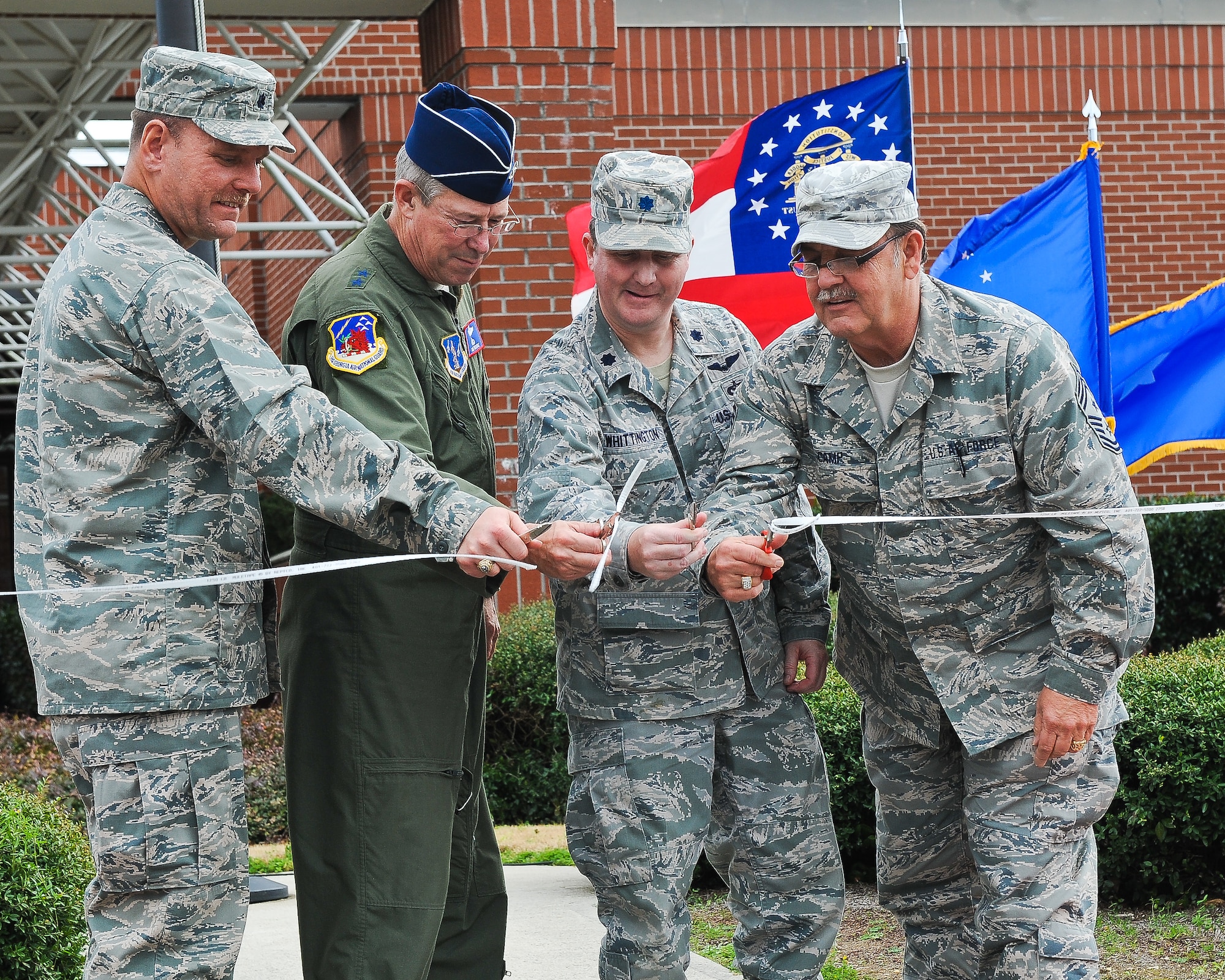 Lt. Col. Fred Walker, 202nd Engineering Installation Squadron (EIS) commander, left, Maj. Gen. Thomas Moore, Georgia Air National Guard commander, Lt. Col. John Whittington, 116th Civil Engineering Squadron, and Command Chief Master Sgt. Donald Camp, Georgia Air National Guard command chief, cut the ribbon during a ceremony to celebrate the new home for the 202nd EIS, Robins Air Force Base, Ga., Jan. 21, 2012.   The 202nd EIS had been stationed at the Macon, Ga., airport since the unit was formed in 1952.   They began the move to their new location in building 2078 at Robins Air Force Base in Sept. 2012.  (Air National Guard photo by Master Sgt. Roger Parsons/Released)