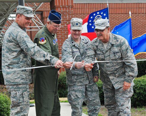 Lt. Col. Fred Walker, 202nd Engineering Installation Squadron (EIS) commander, left, Maj. Gen. Thomas Moore, Georgia Air National Guard commander, Lt. Col. John Whittington, 116th Civil Engineering Squadron, and Command Chief Master Sgt. Donald Camp, Georgia Air National Guard command chief, cut the ribbon during a ceremony to celebrate the new home for the 202nd EIS, Robins Air Force Base, Ga., Jan. 21, 2012.   The 202nd EIS had been stationed at the Macon, Ga., airport since the unit was formed in 1952.   They began the move to their new location in building 2078 at Robins Air Force Base in Sept. 2012.  (Air National Guard photo by Master Sgt. Roger Parsons/Released)