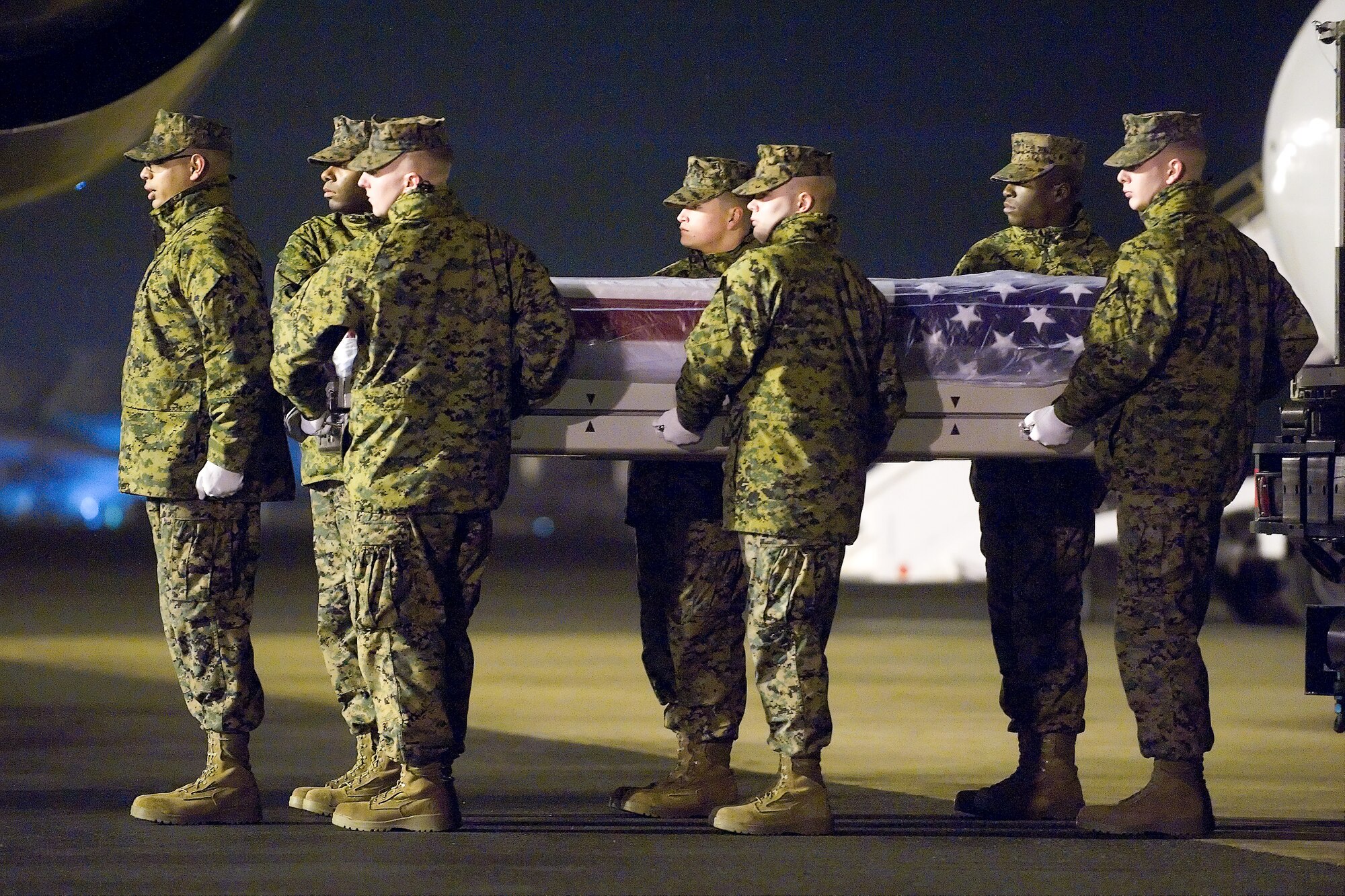 A U.S. Marine Corps carry team transfers the remains of Marine Capt. Nathan R. McHone, of Crystal Lake, Ill., at Dover Air Force Base, Del., Jan. 23, 2012. McHone was assigned to Marine Heavy Helicopter Squadron 363, Marine Aircraft Group 24, 1st Marine Aircraft Wing, III Marine Expeditionary Force, Kaneohe Bay, Hawaii. (U.S. Air Force photo/Steve Kotecki)