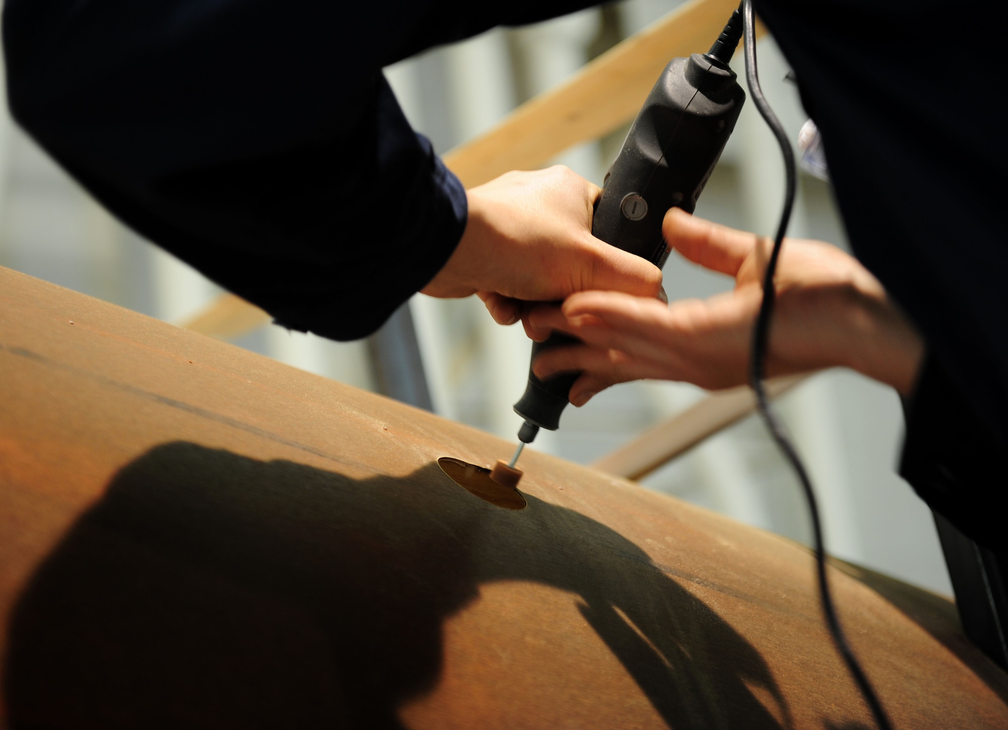 U.S. Air Force Tech. Sgt. Jason Kraener, 94th Aircraft Maintenance Unit aircraft section chief, smoothes the edges of the Nieuport 28 replica at Langley Air Force Base, Va., Jan. 17, 2012.  Retired U.S. Air Force Col. Jon Goldenbaum provided the fabric, coatings and custom tinted military specification paint to the restoration of the Nieuport 28.  (U.S. Air Force photo by Airman 1st Class Kayla Newman/Released) 