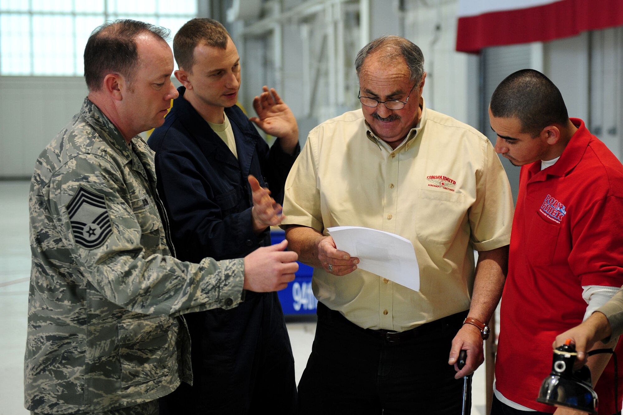 Retired U.S. Air Force Col. Jon Goldenbaum, second from right, helps Airmen of the 94th Aircraft Maintenance Unit restore a Nieuport 28 replica at Langley Air Force Base, Va., Jan. 17, 2012. Goldenbaum was stationed at Langley AFB in the 1980’s and participated in the original dedication ceremony when the Nieuport 28 model was unveiled.  (U.S. Air Force photo by Airman 1st Class Kayla Newman/Released) 