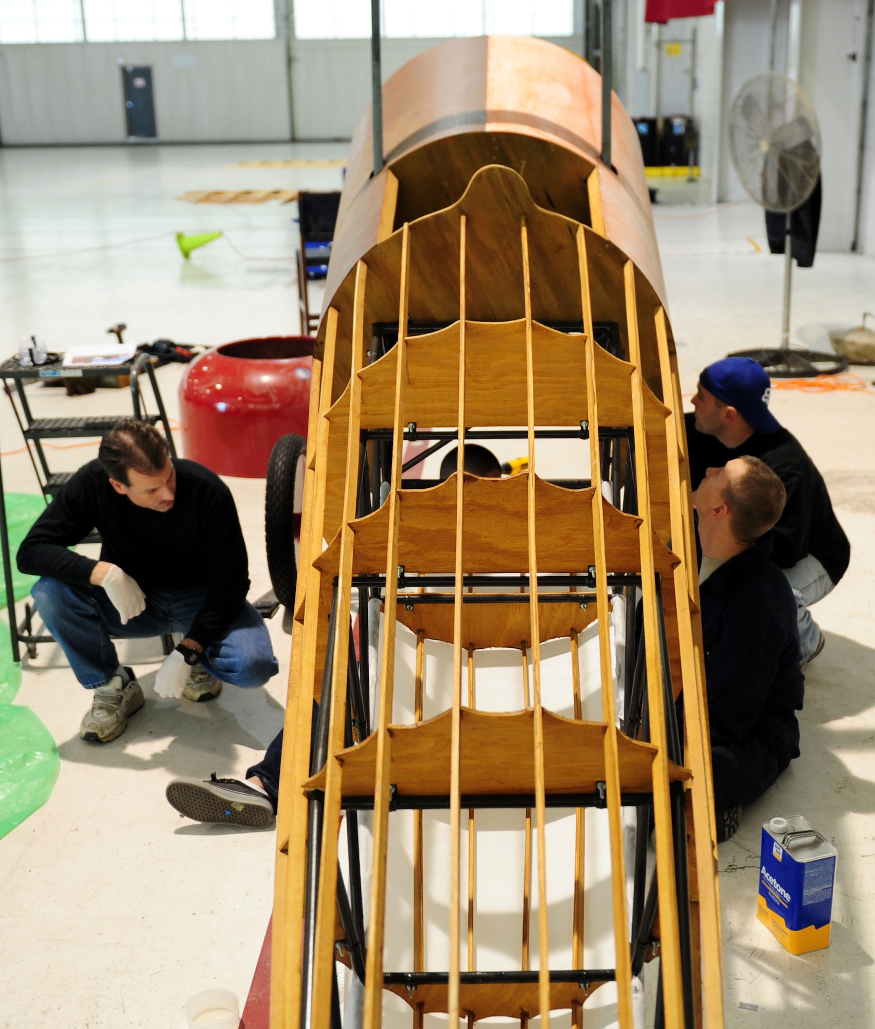 Airmen assigned to the 94th Aircraft Maintenance Unit build a Nieuport 28 replica at Langley Air Force Base, Va., Jan. 17, 2012.  The original Nieuport 28 replica was put on display in front of the 94th AMU in 1984, and has since gone through two restorations, two location moves, three mountings, and one final flight.  (U.S. Air Force photo by Airman 1st Class Kayla Newman/Released) 