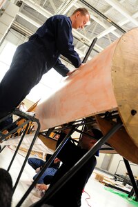 U.S. Air Force Tech. Sgt. Jason Kraener, 94th Aircraft Maintenance Unit aircraft section chief, and Master Sgt.  Aaron Cowan, 94th AMU production superintendent, rebuild the Nieuport 28 replica  at Langley Air Force Base, Va., Jan. 17, 2012.  The restoration project at Langley AFB  involves select Airmen using skills rarely employed in today’s Air Force.  (U.S. Air Force photo by Airman 1st Class Kayla Newman/Released) 