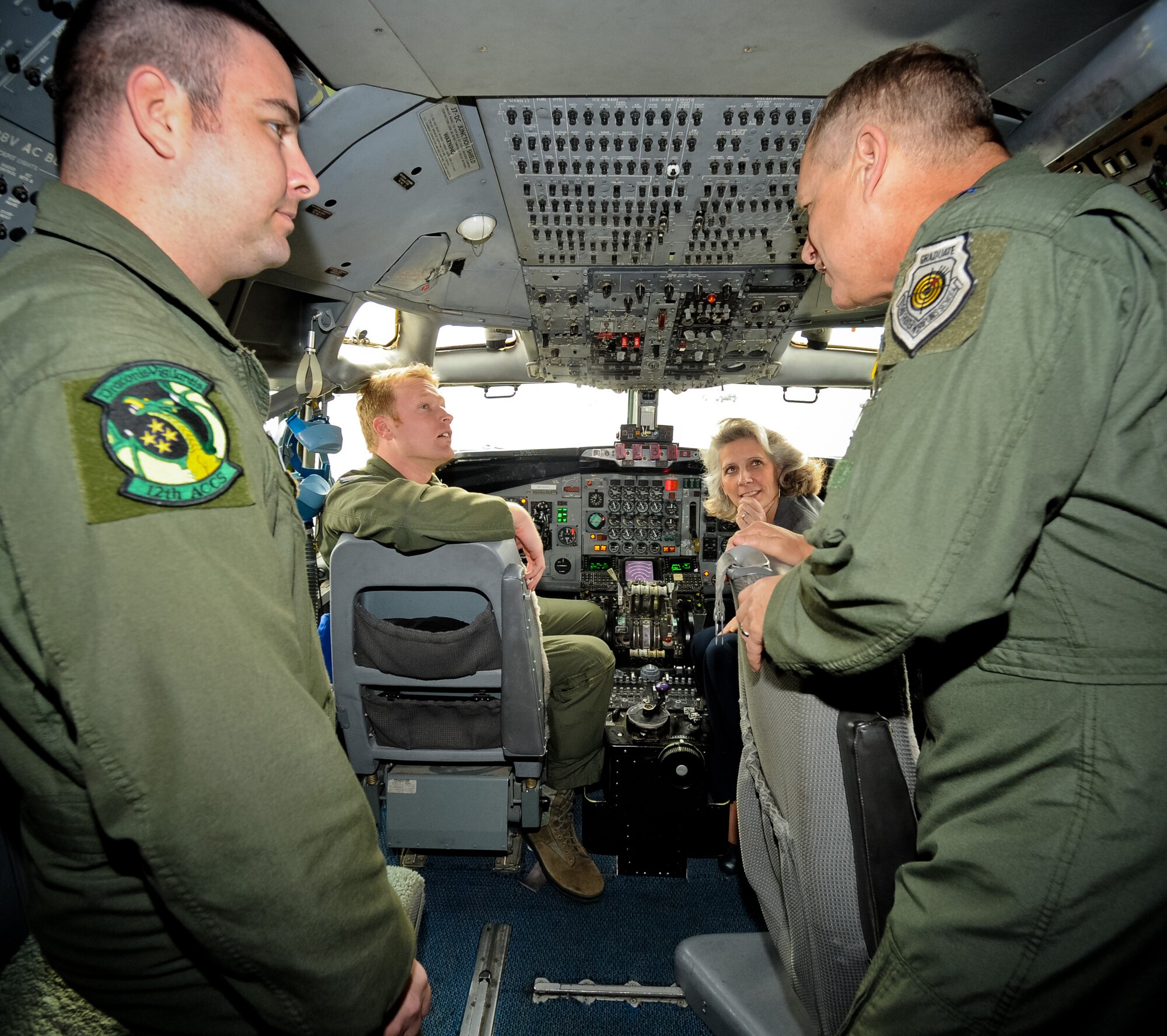Maj. Gen. Lawrence Wells, 9th Air Force commander, right, and his wife Kathy Wells, talk with E-8 Joint STARS crewmembers, Staff Sgt. Brian Bosworth, left, and Capt. Zachary Tews during a visit to Robins Air Force Base, Ga., Jan. 17, 2012.  Wells toured the jet during a two-day trip to JSTARS for an orientation of the 461st Air Control Wing.  This was Wells' first visit since the activation of the 461st ACW.   (Air National Guard photo by Master Sgt. Roger Parsons/Released)