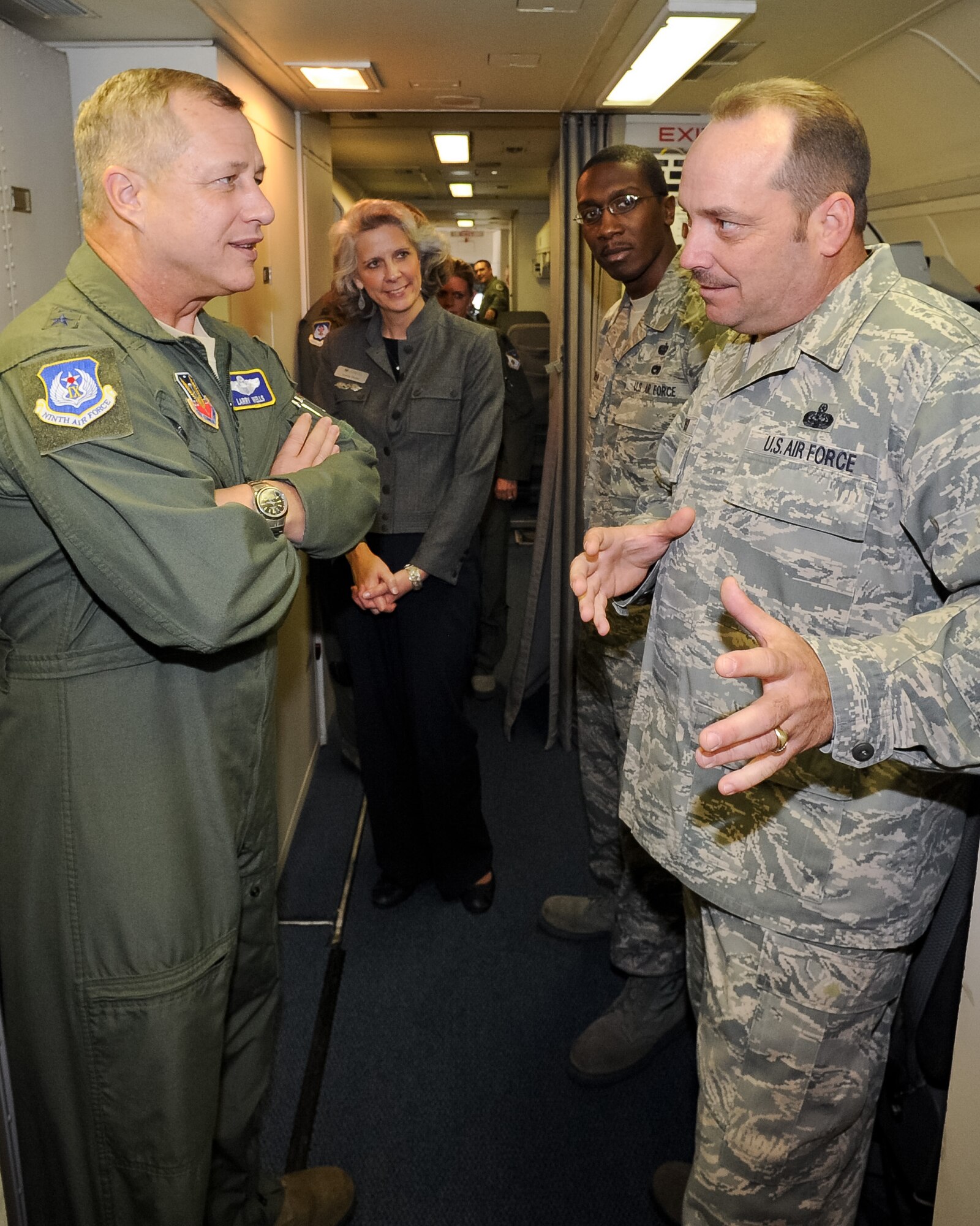 Senior Master Sgt. Weldon Benson, 461st Computer Systems Squadron, right, briefs Maj. Gen. Lawrence Wells, 9th Air Force commander, on the capabilities of the computer systems aboard the E-8 Joint STARS, as Wells wife, Kathy Wells, and Staff Sgt. Demetris Coleman, 461st CSS, look on, Robins Air Force Base, Ga., Jan. 17, 2012.  This was Wells' first visit to  JSTARS since the activation of the 461st ACW.   (Air National Guard photo by Master Sgt. Roger Parsons/Released)