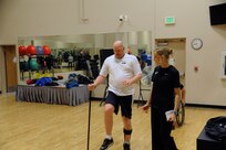 Keith Sekora, a participant in the Air Force Adaptive Fitness and Sports Camp receives instructions from Heather Pennington , strength conditioning coach, on how to strengthen muscles in the legs on Joint Base San Antonio-Randolph Jan. 20. ( U.S. Air Force photo by Don Lindsey) (released)